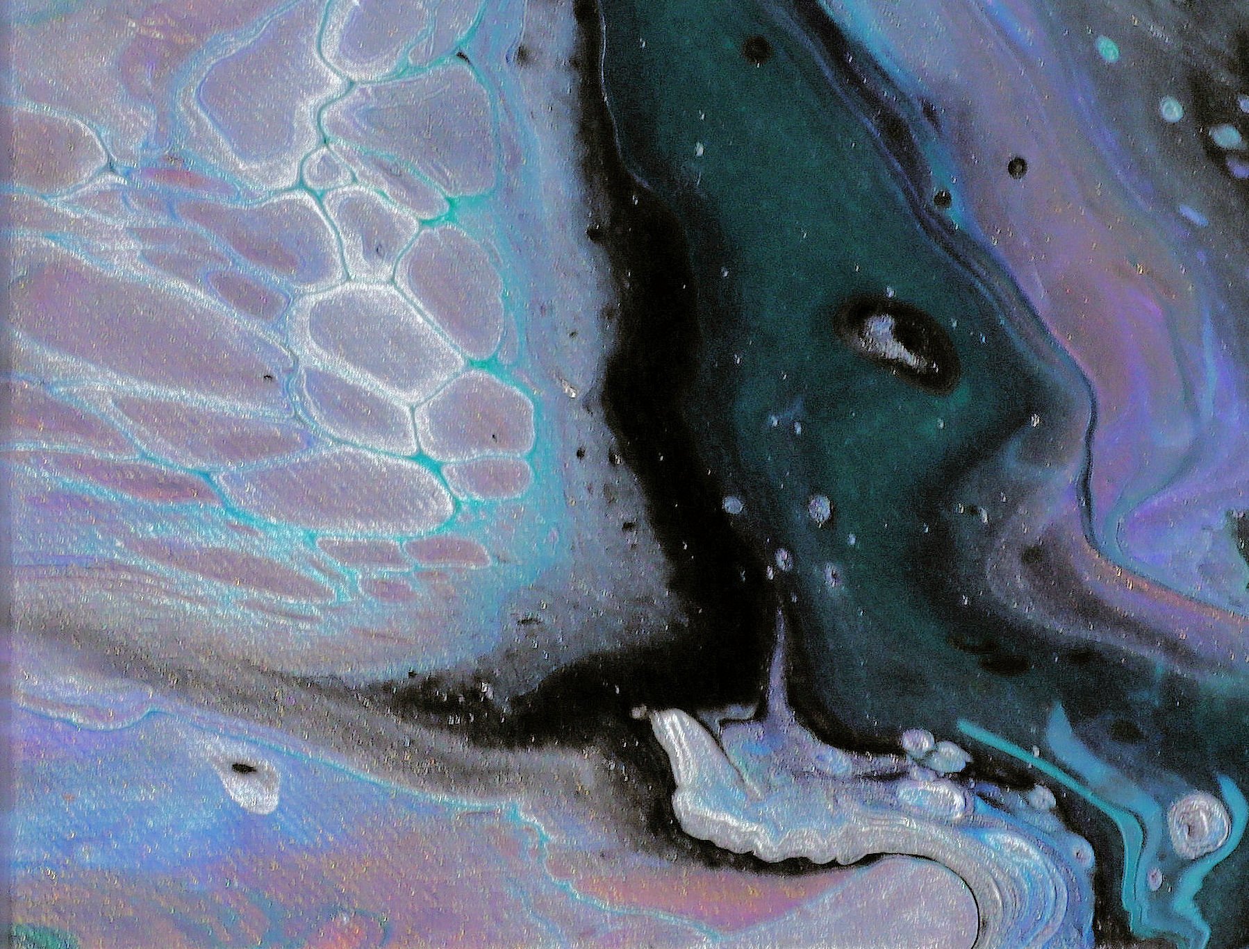 Close-up of iridescent soap bubbles with swirling colors and patterns.