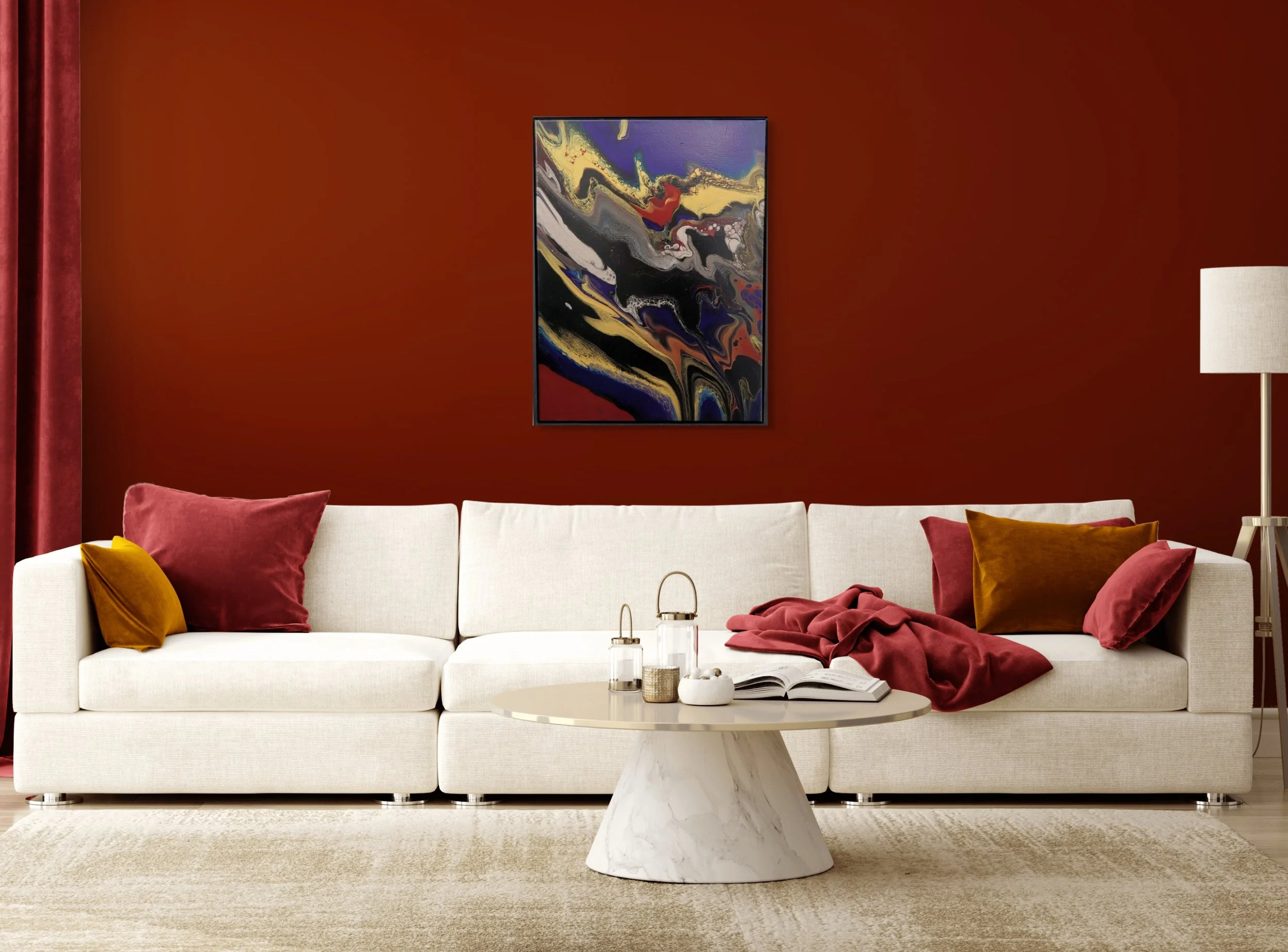 Living room with white sofa, maroon and mustard pillows, a round marble coffee table with decorative items, torso-shaped white and gold decor, wall art with abstract design, and a floor lamp with white shade against a red wall.