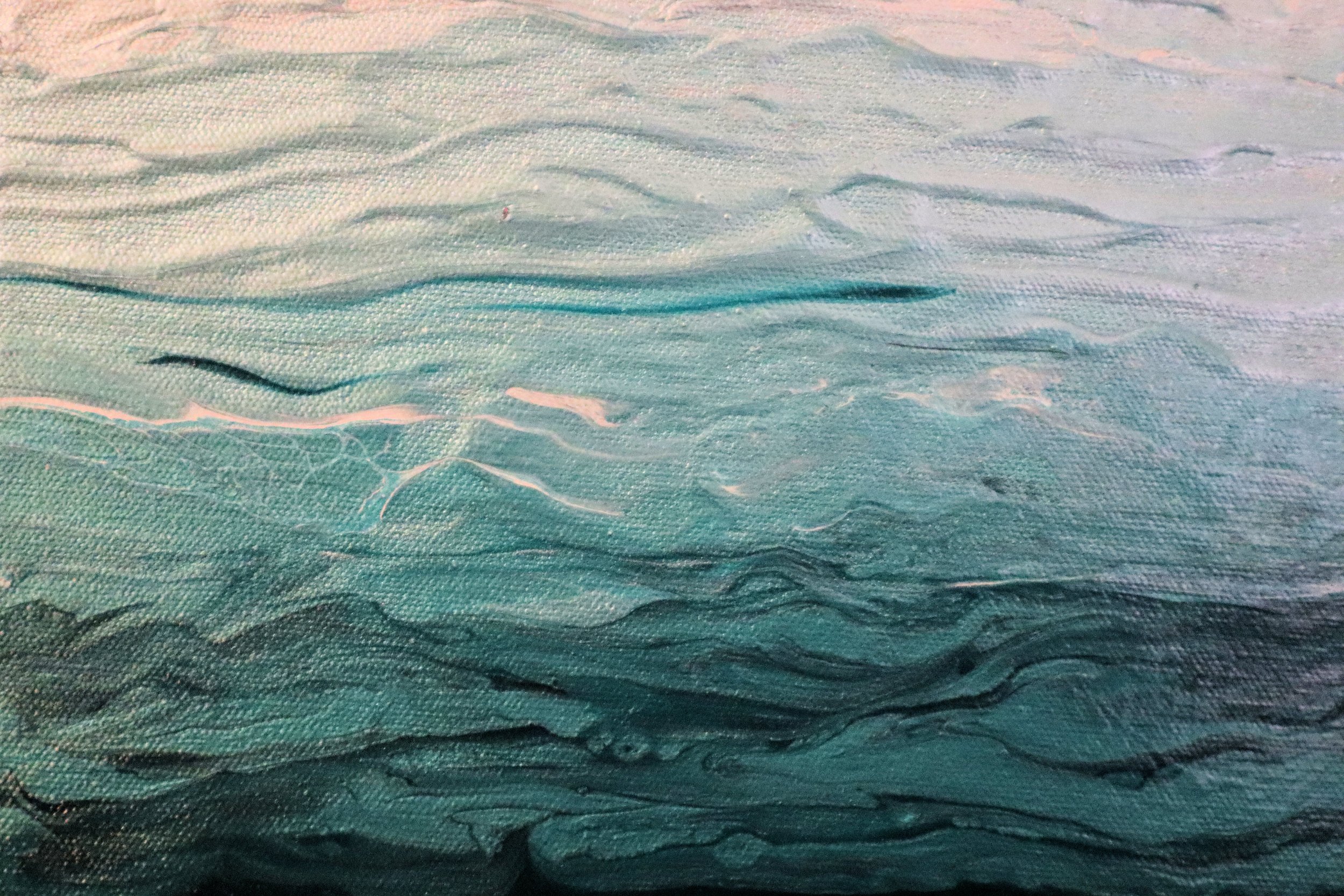 Close-up of textured fabric with ripples and shadows, in shades of teal and green.