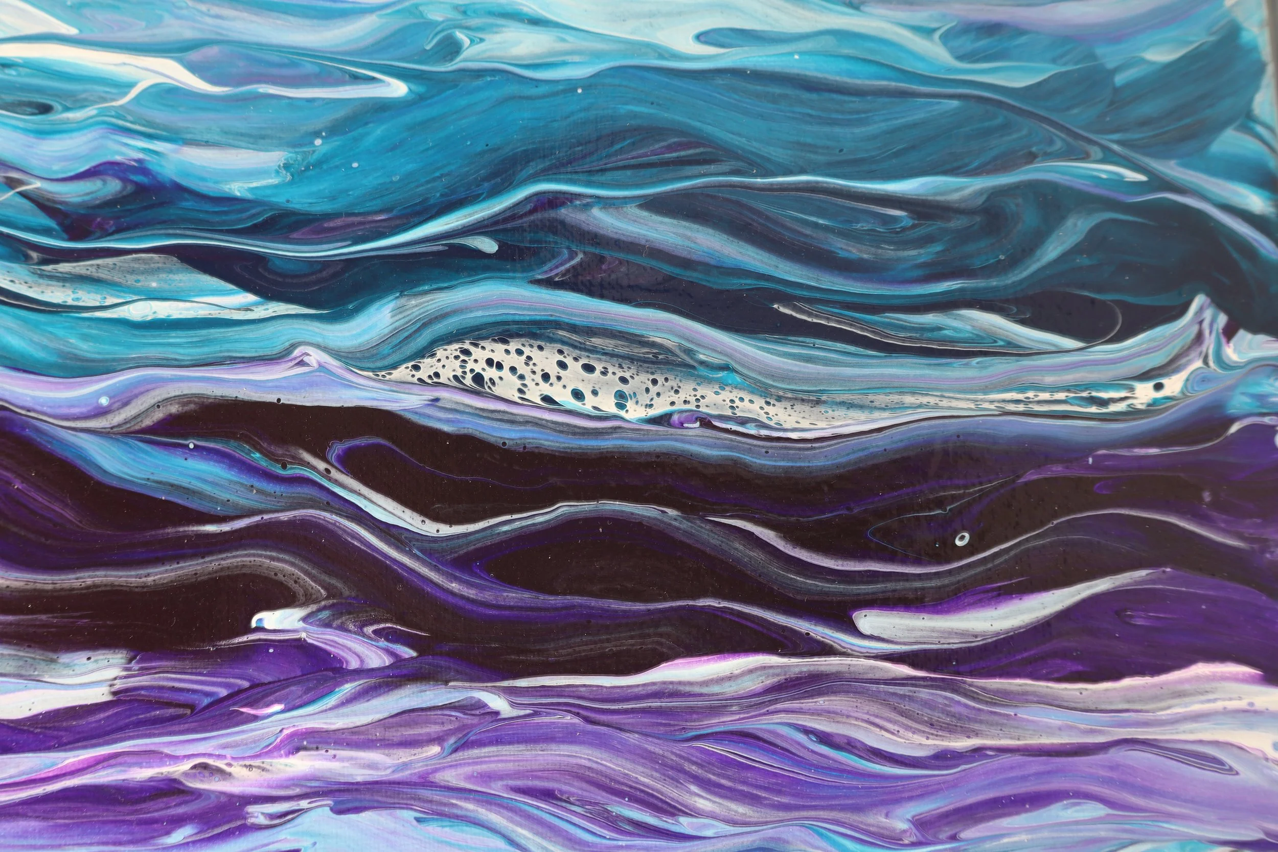 Abstract painting with swirling patterns in shades of blue, purple, white, and black.