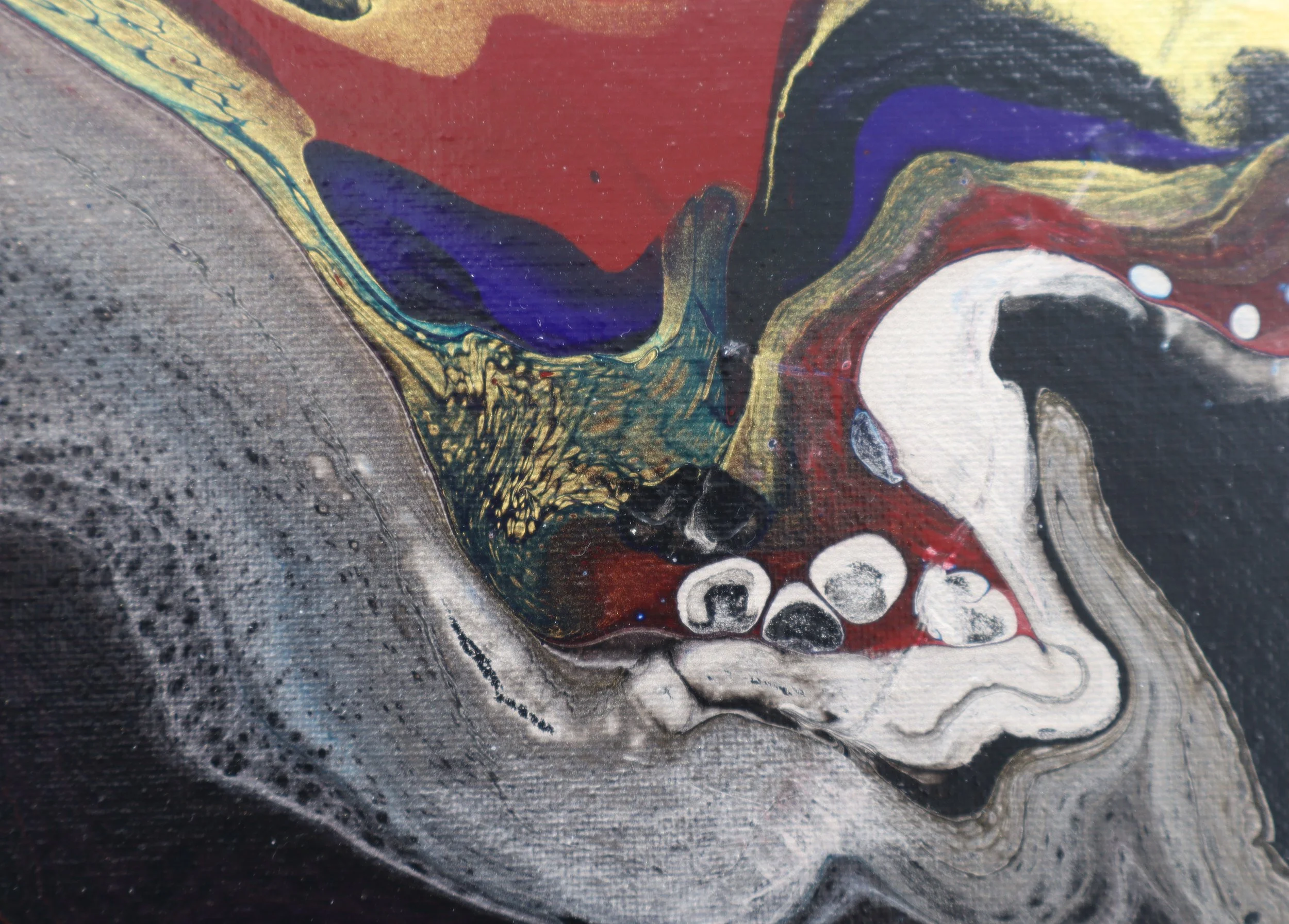 Close-up of abstract colorful painting with swirls of red, blue, yellow, black, and white paint.