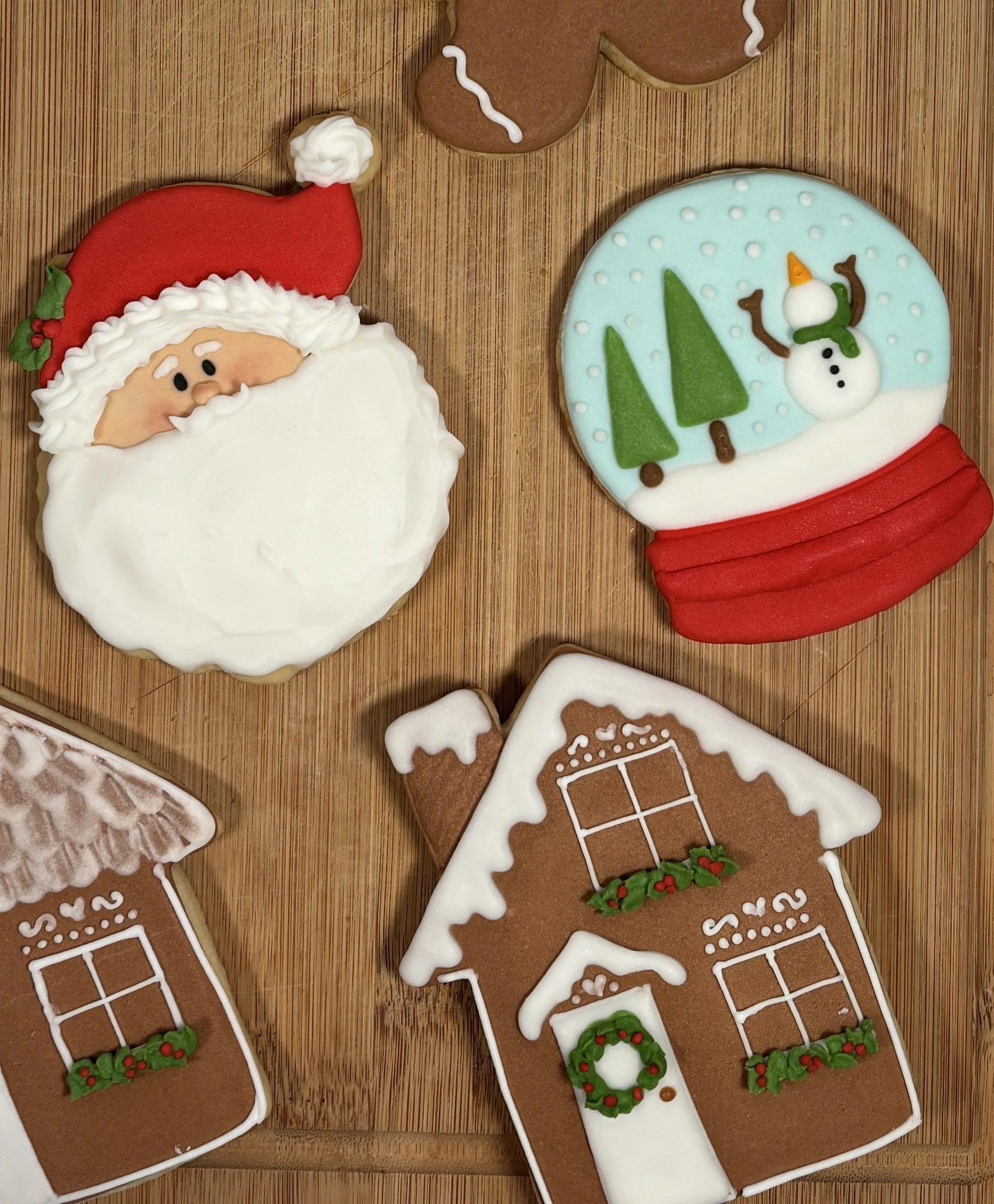 Decorated Christmas cookies — Santa, snowman, and gingerbread house form Mary's Bakehouse