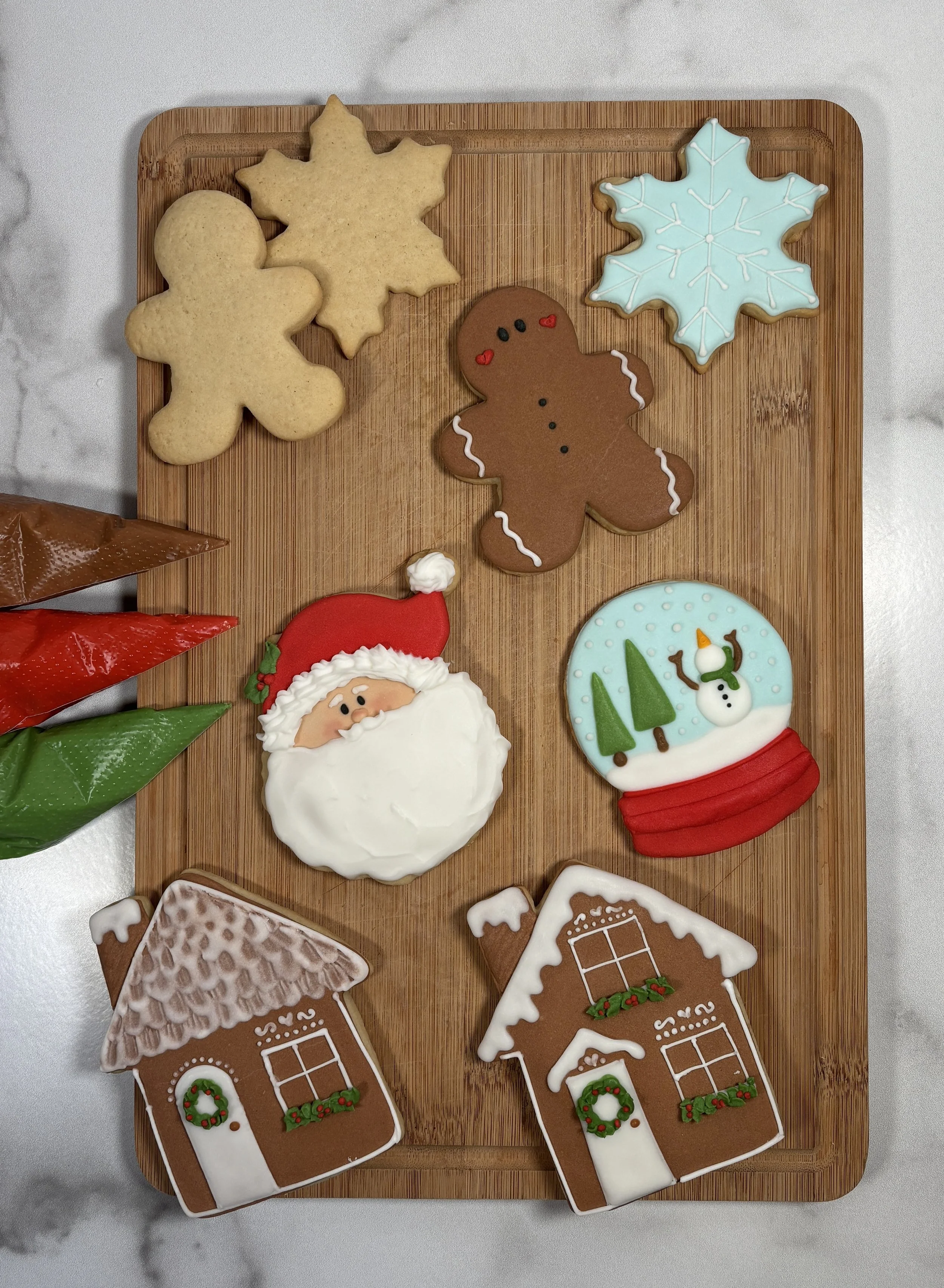 Custom holiday cookies — gingerbread men, snowflakes, Santa, and snowman from Mary's Bakehouse