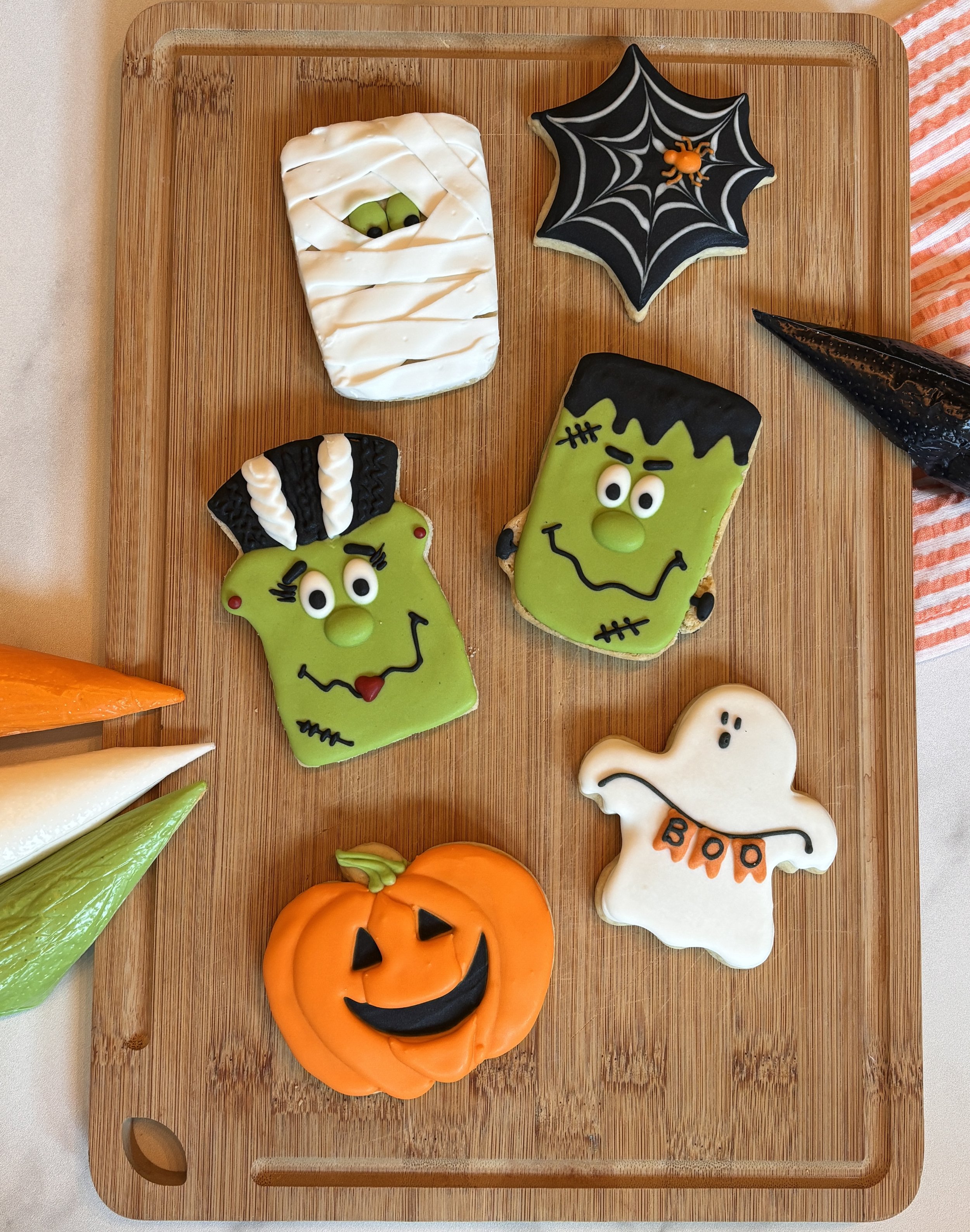Custom Halloween decorated cookies — Frankenstein, ghost, spider, and pumpkins from Mary's Bakehouse