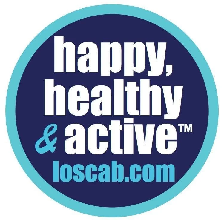 Circular logo with a dark blue background and light blue border, featuring the text 'happy, healthy & active' in large white and blue letters, and the website 'loscab.com' at the bottom.