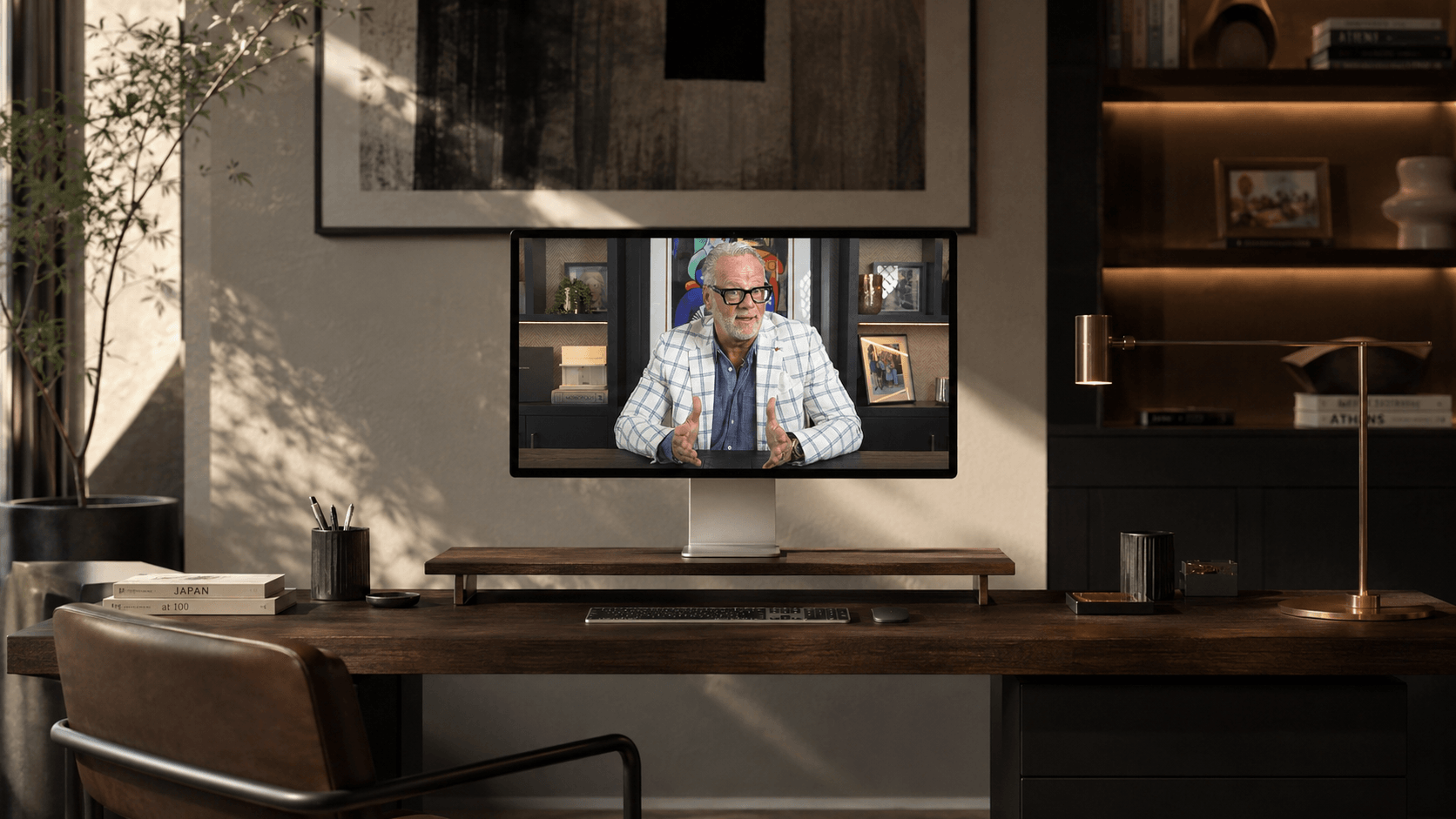 A computer monitor on a wooden desk displays Wayne Visbeen's newest video course, Architecting the Sale.
