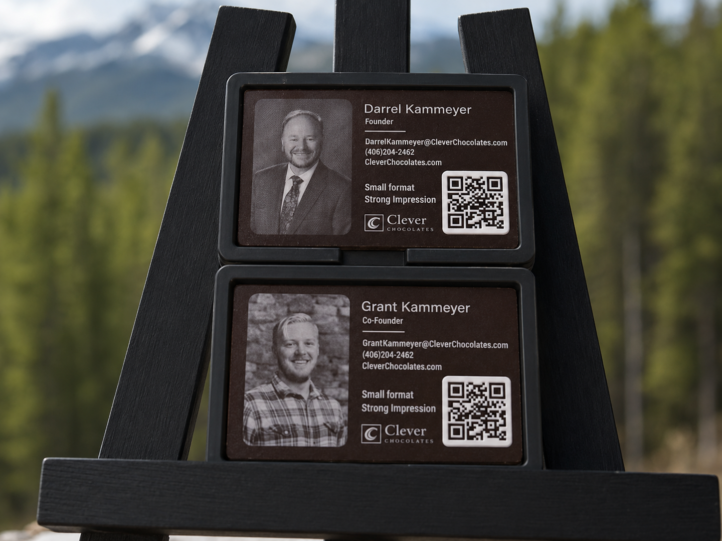 Clever Chocolates edible business cards for co-founders Darrel and Grant Kammeyer, displayed against a mountain resort backdrop.