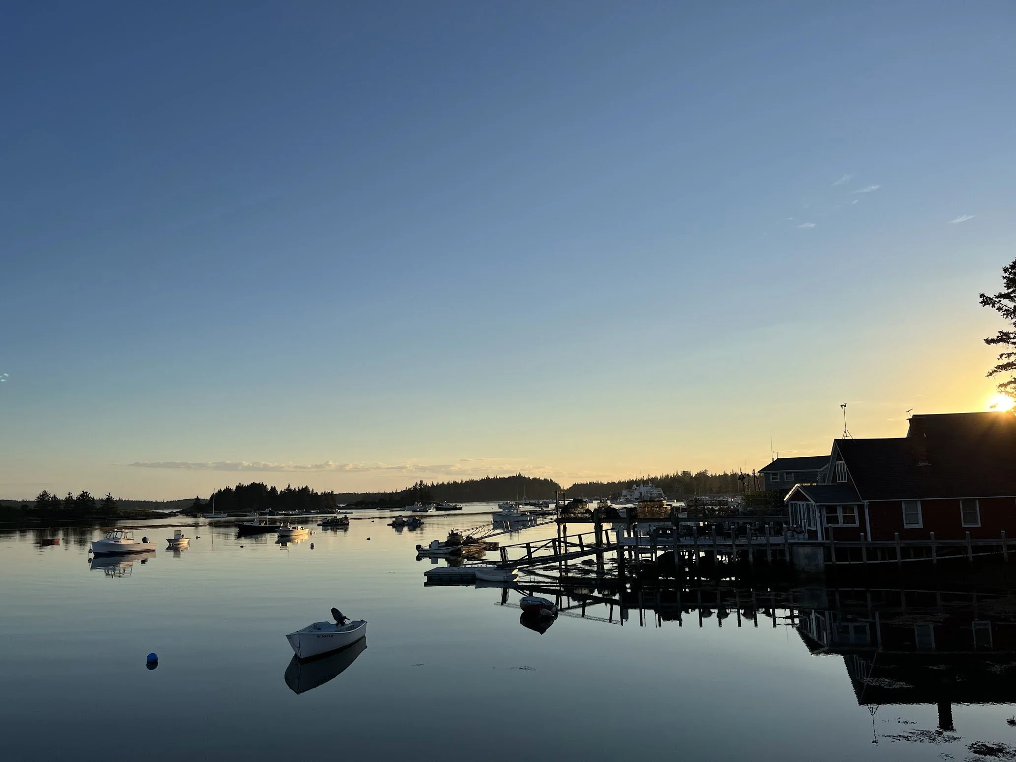 Boats in a harbor with a sunset  backgroundin Maine.