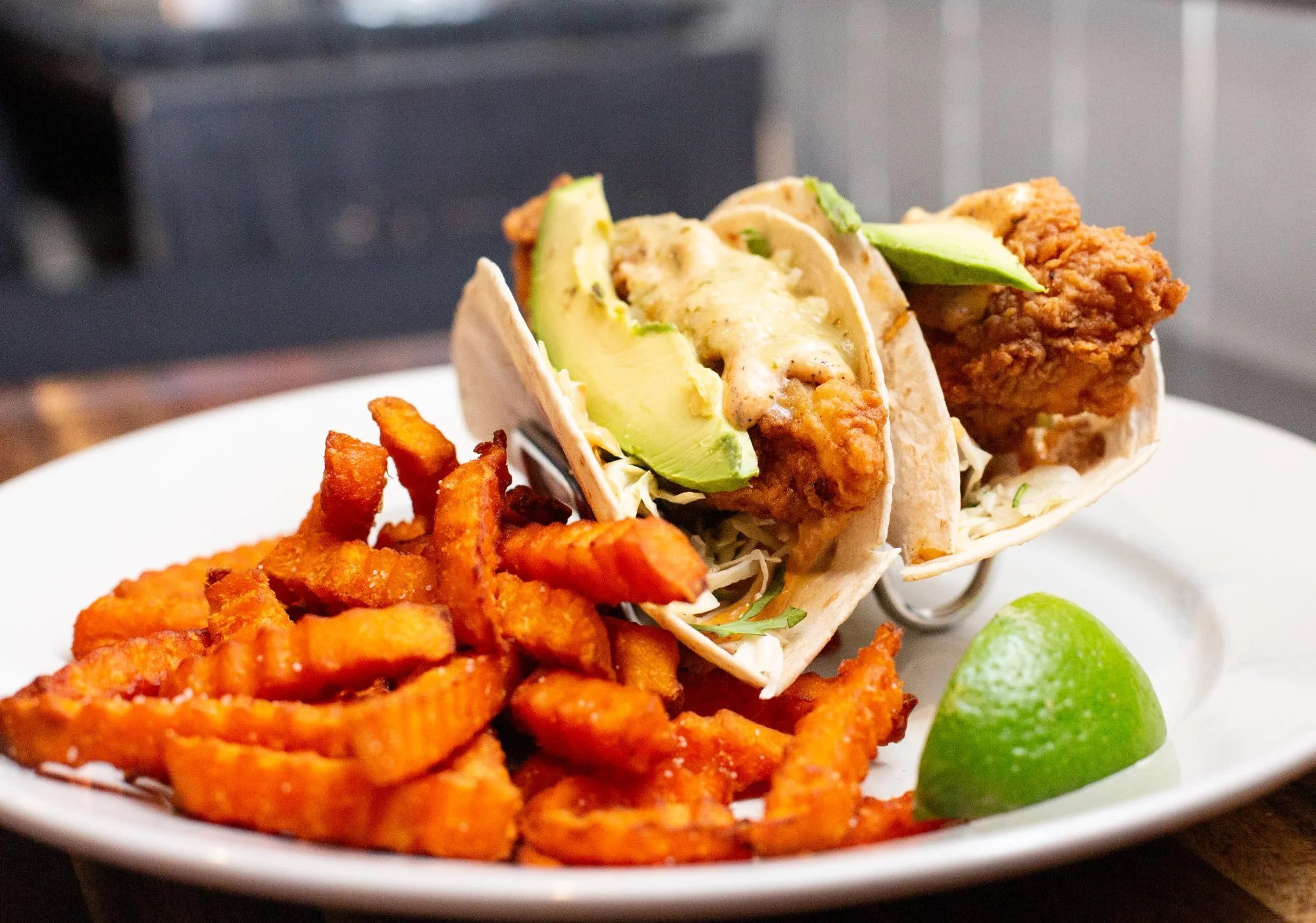 Gulf grouper fish tacos with avocado, cabbage and sweet potato fries at Windward Tavern in Alpharetta, Georgia