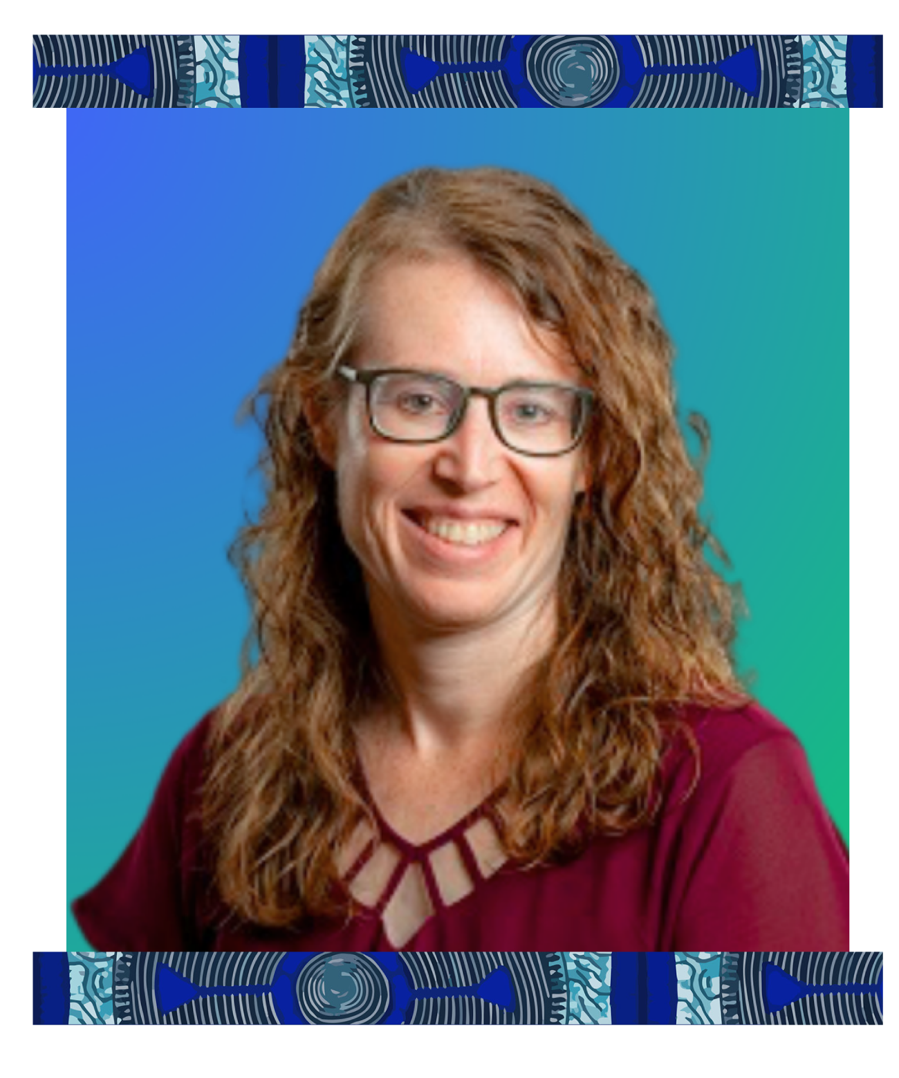 Portrait of a woman with long curly red hair and glasses, smiling, wearing a burgundy top with geometric cutouts, against a gradient blue-green background.