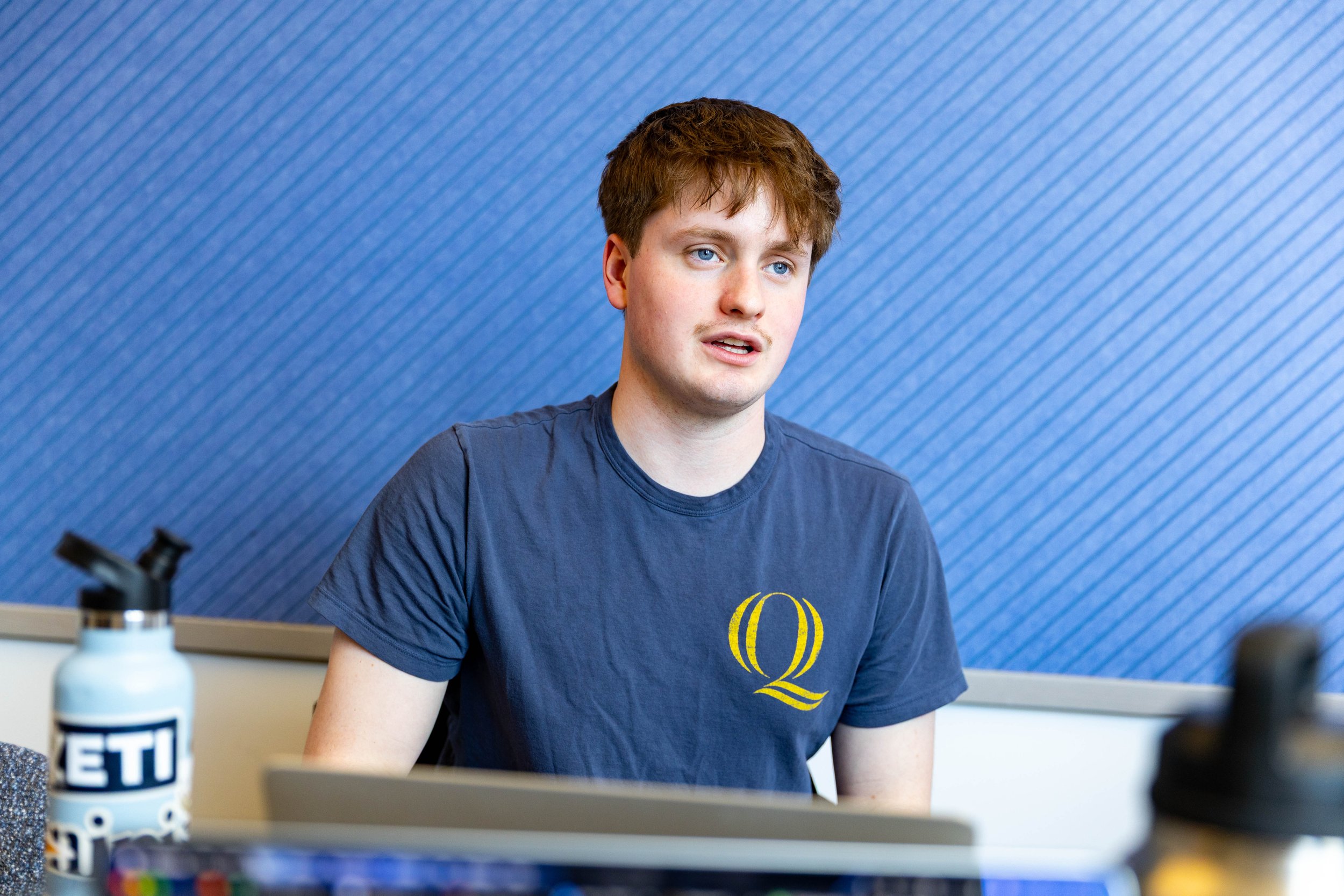 Man sharing his thoughts during a TEDxQuinnipiacU team meeting