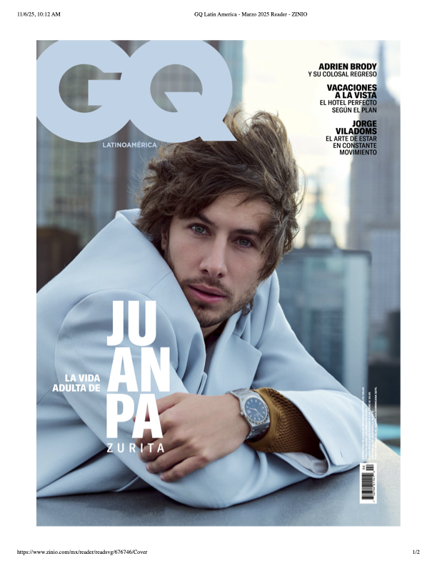 Cover of GQ Latin America magazine featuring Juanpa Zurita, a young man with medium-length wavy hair, wearing a light blue blazer and a watch, leaning on a rooftop with city buildings in the background.