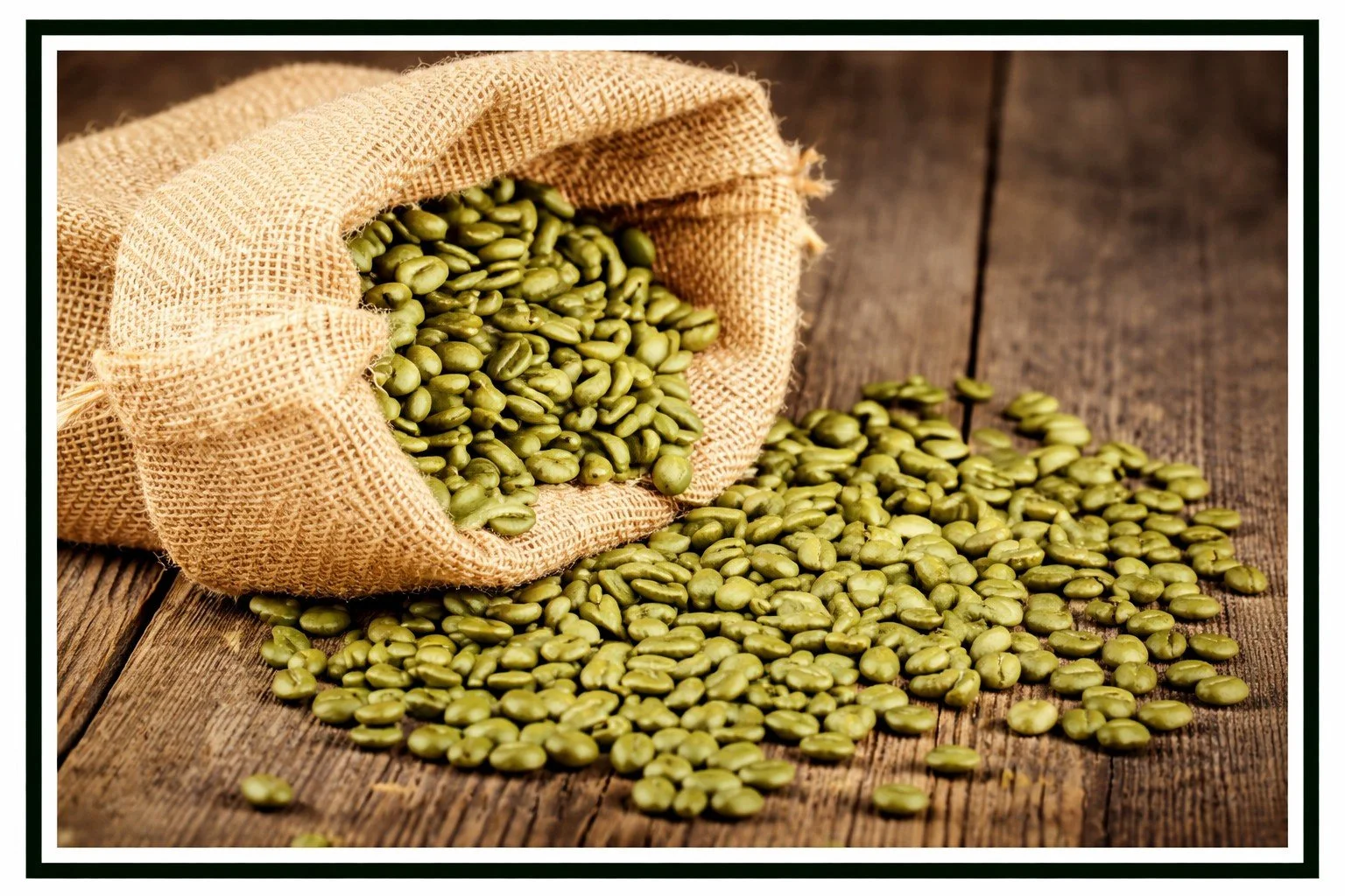 Green coffee beans spilling out of a burlap sack onto a table.