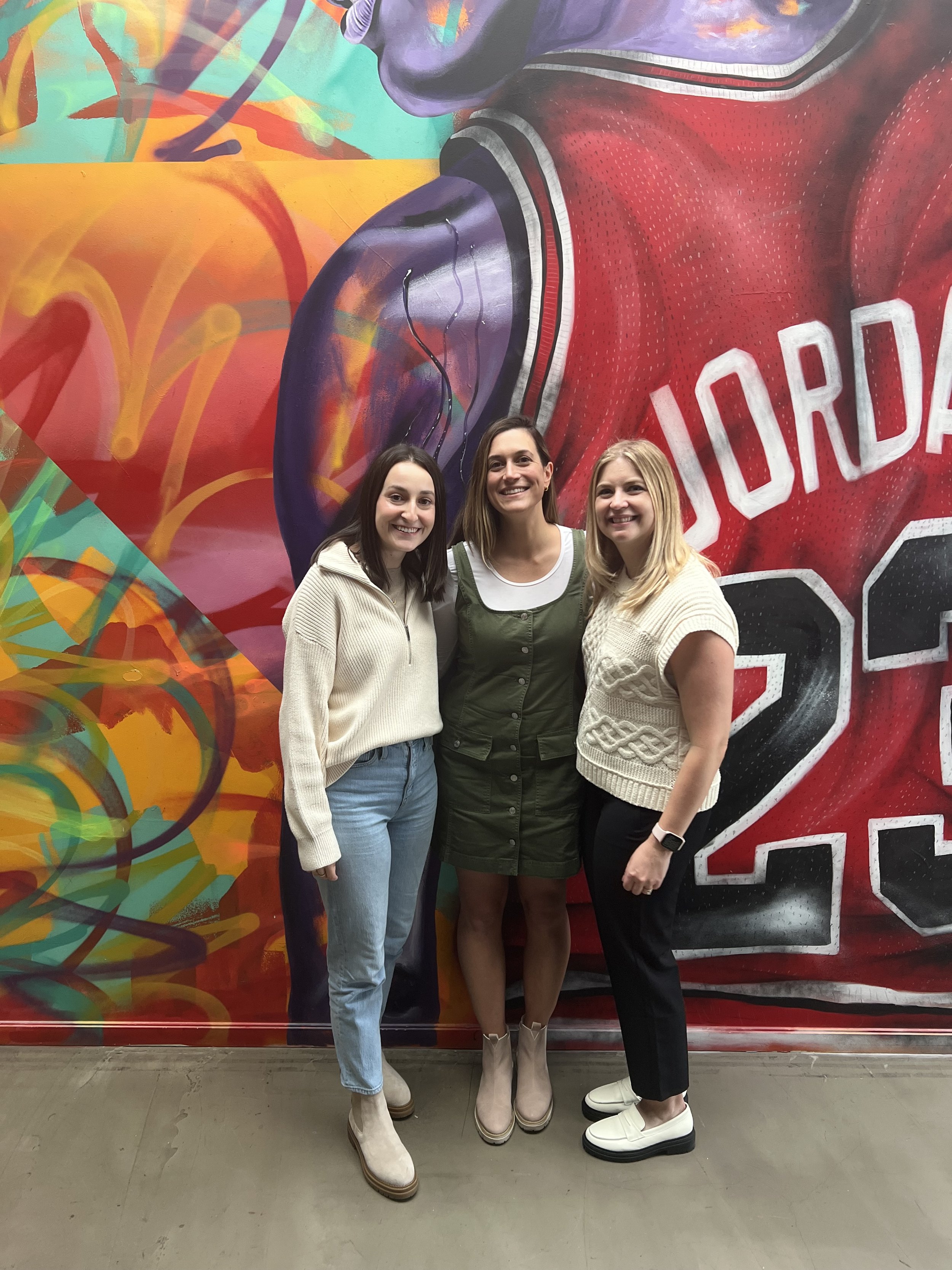 Vanessa Giolitto with colleagues at Bleacher Report's San Francisco office in front of Michael Jordan mural.