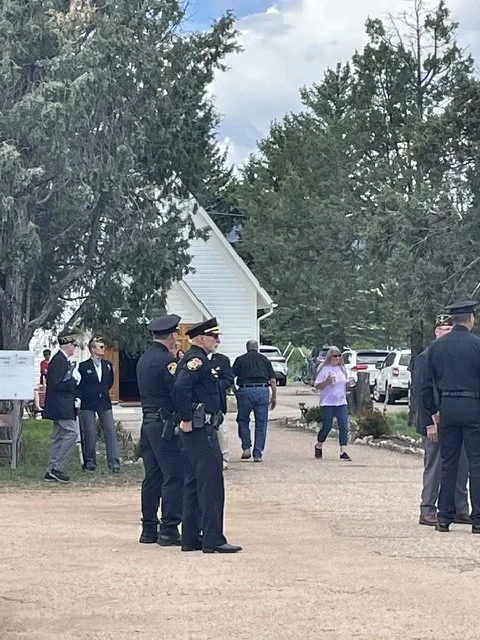 Police officers and community members honor those who served on Memorial Day event hosted by the Daughters of the Revolution (DAR) and Saint Philip in the Field 