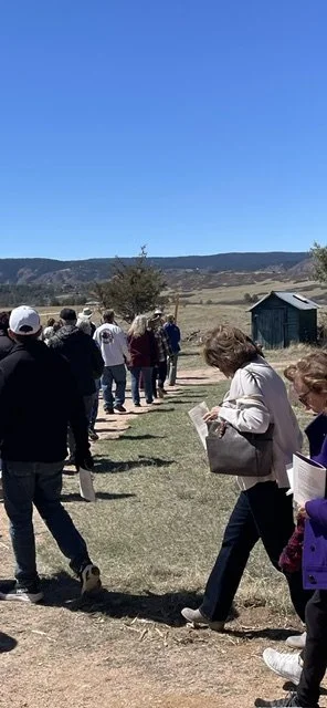 Walking behind the Cross toward the mountains on Good Friday 2026