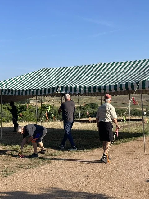 Raising the tent in the beautiful summer morning before "mass on the grass"