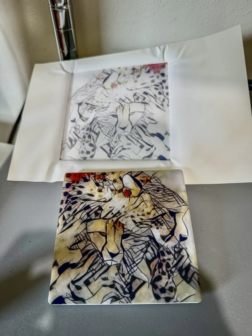 Linda Detwiler Burner creating custom sublimation artwork with a lion design on coaster.