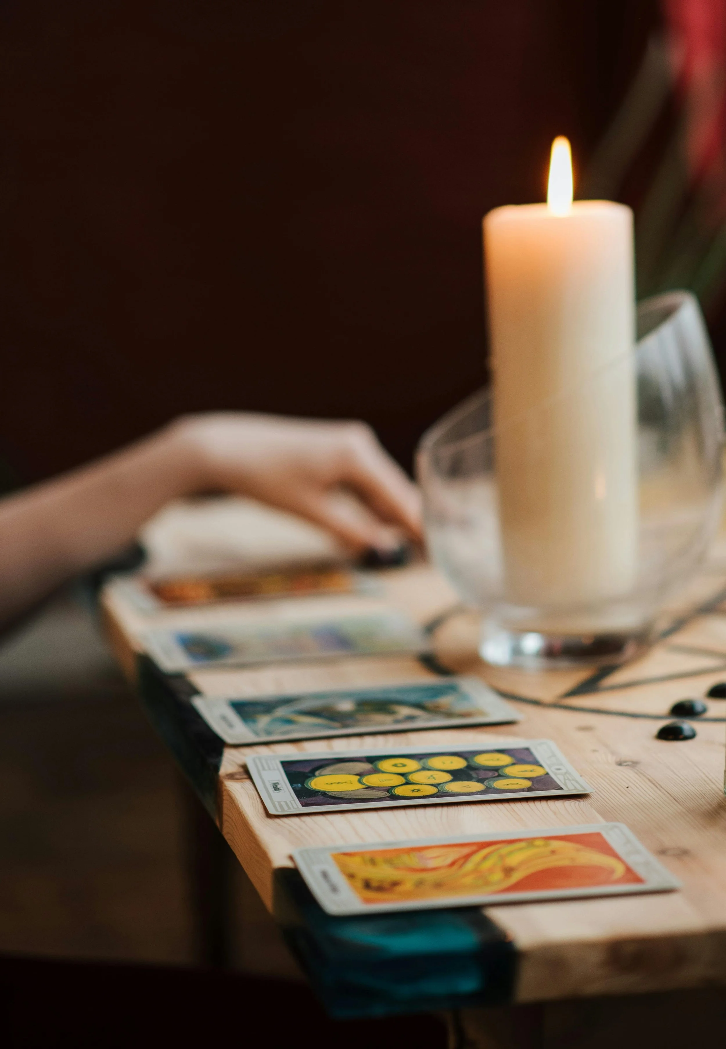 Tarot cards laid out on a wooden table by candlelight during a reading — Torch & Tower Tarot Readings Denver