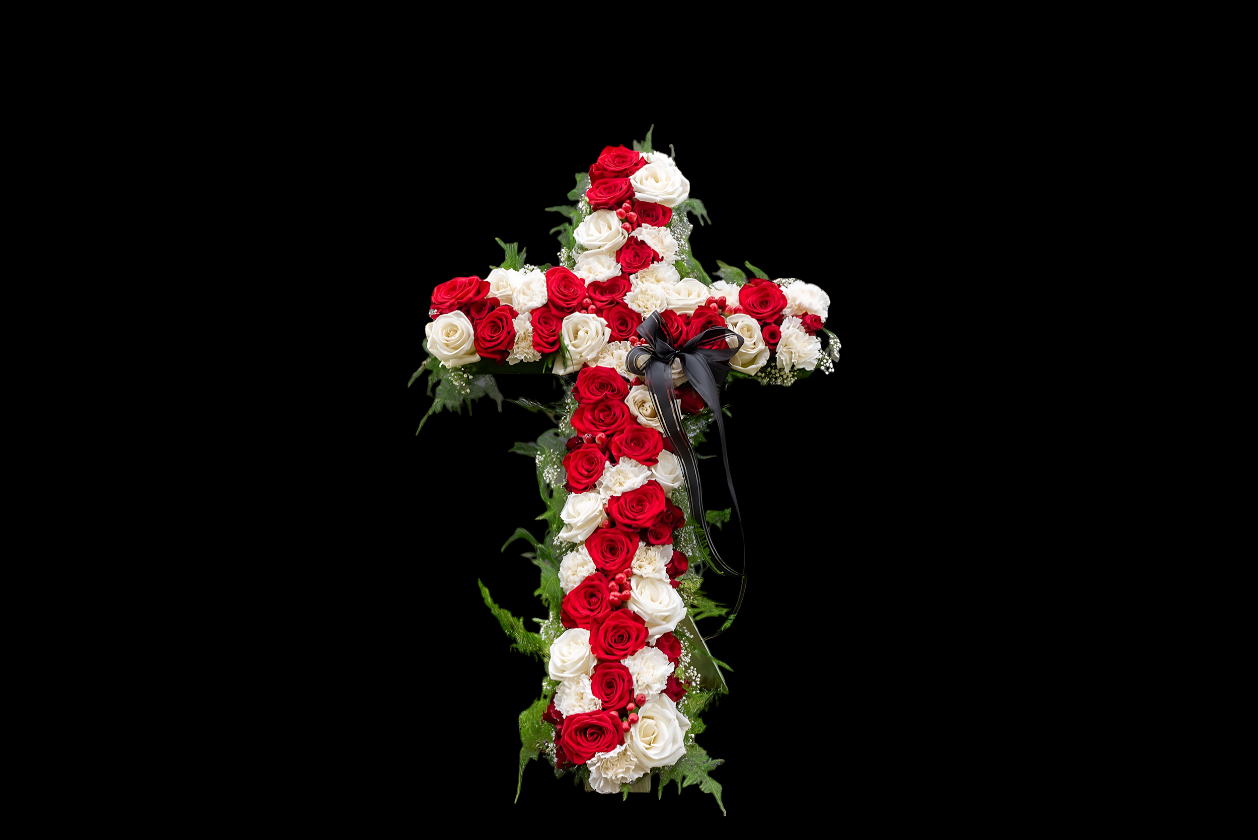 Red and white roses arranged on a black background, with green leaves, forming the shape of a cross with a black ribbon near the bottom.