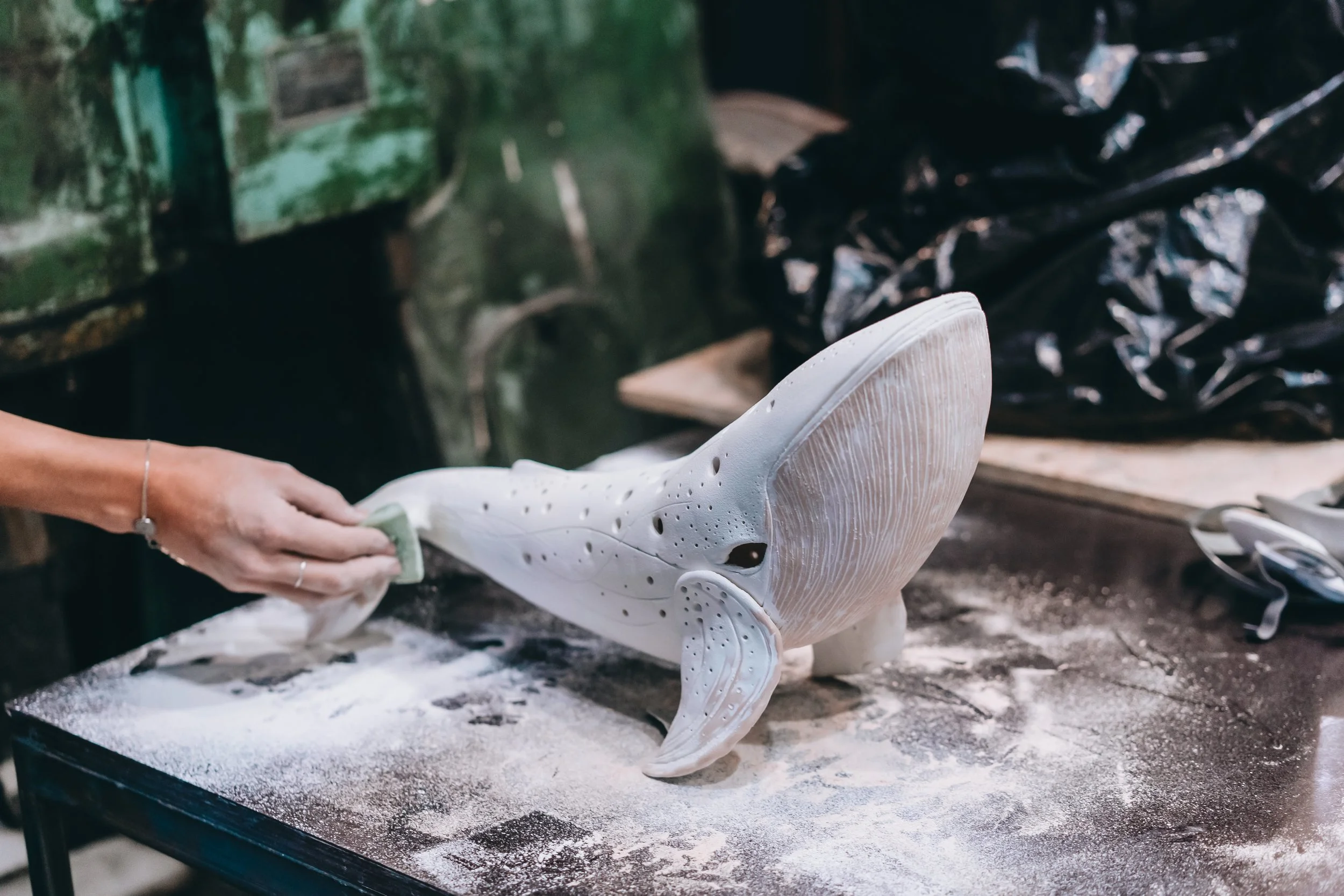 portrait-young-woman-enjoying-favorite-job-workshop-potter-carefully-works-ceramic-whale.jpg