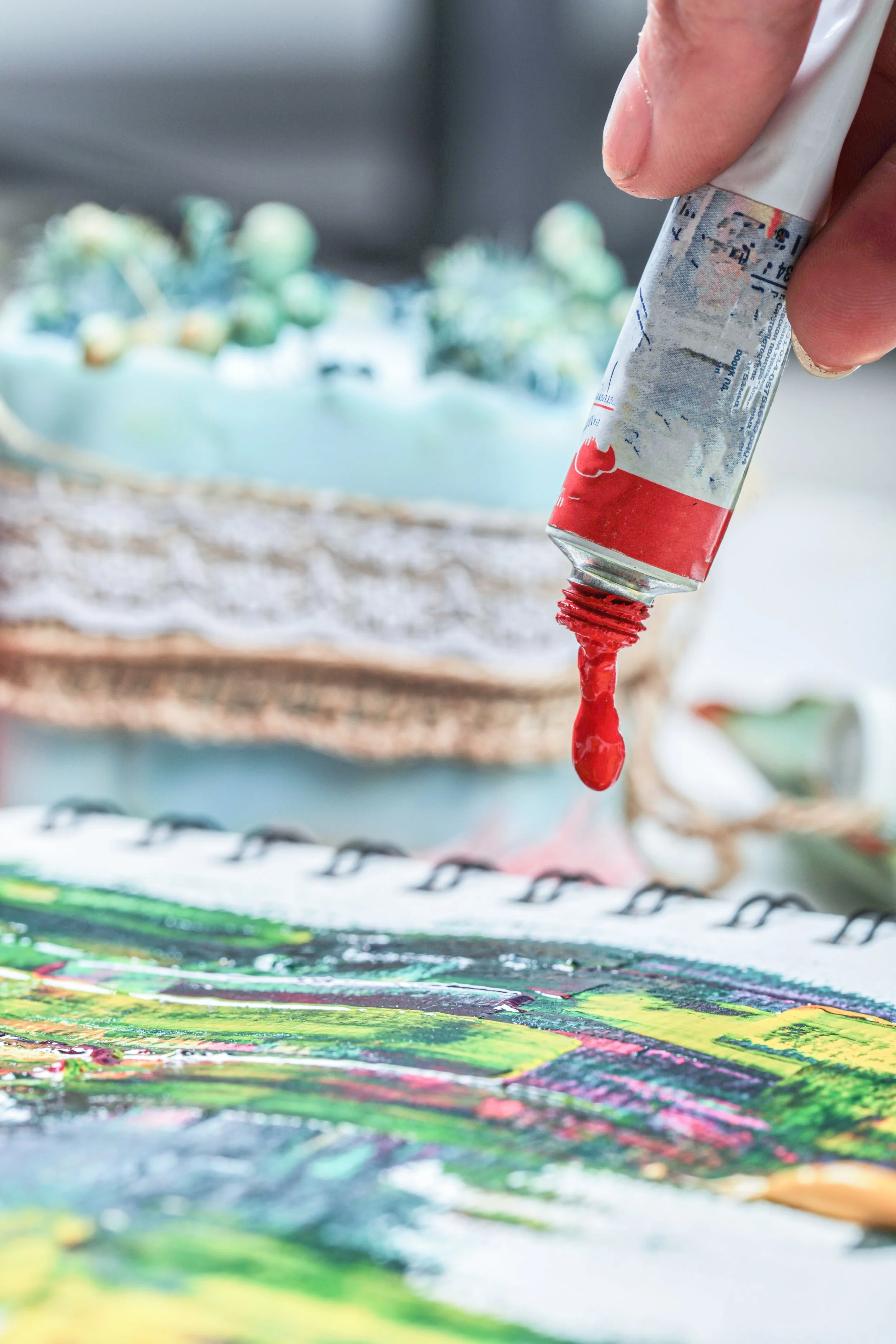 hand-woman-drawing-painting-picture-with-painting-tubes.jpg