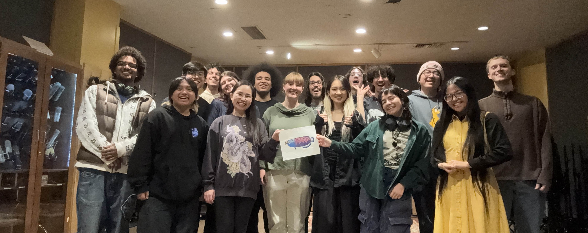 An image of riko with the 2025-2026 Audire Board Members after the Fall 2025 recording session. They are the second from the right in the back row.