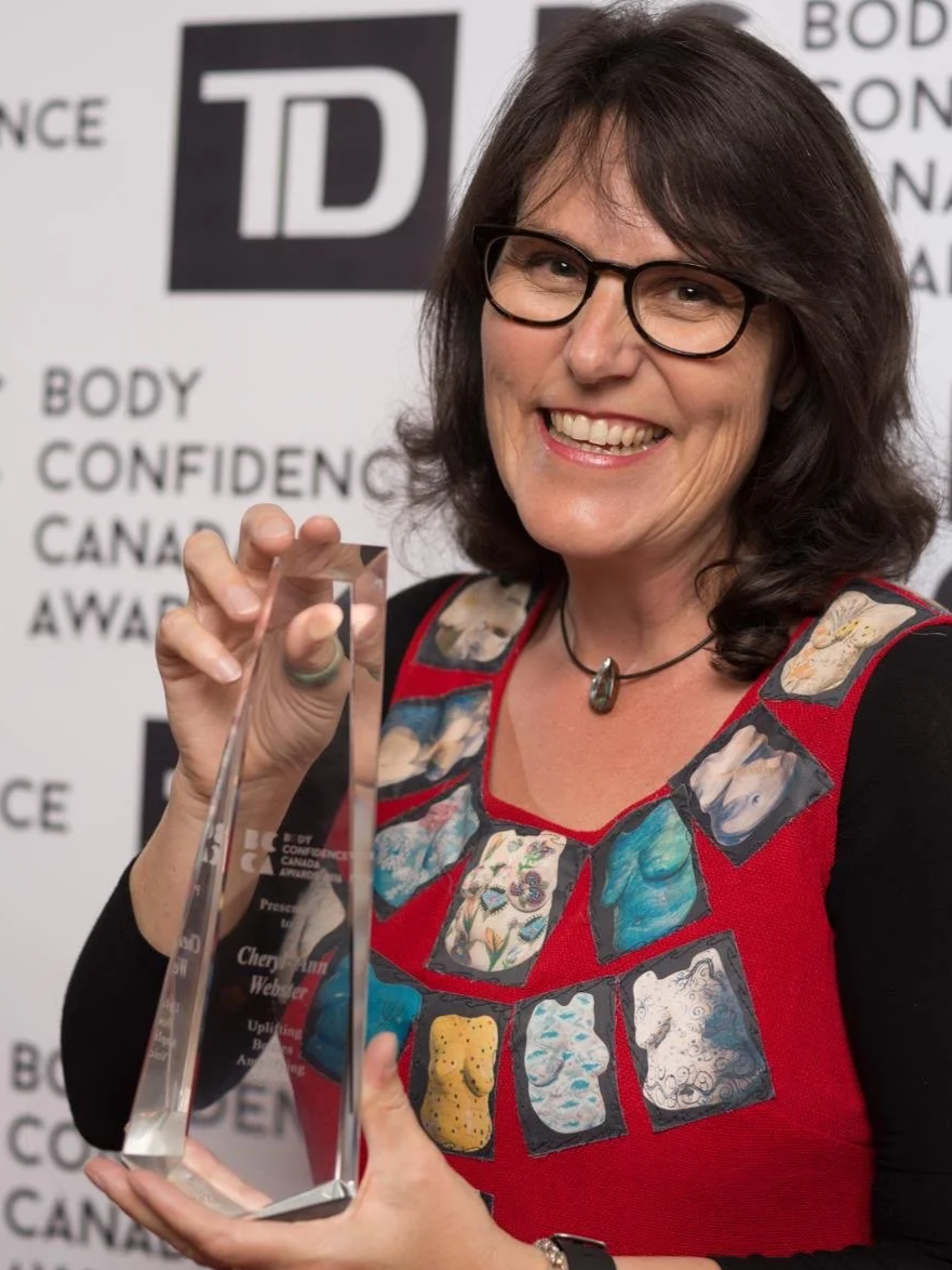 At the Body Confidence Canada Awards in Toronto — marking a moment of recognition for The Beautiful Women Project, wearing a dress featuring all 120 sculptures.