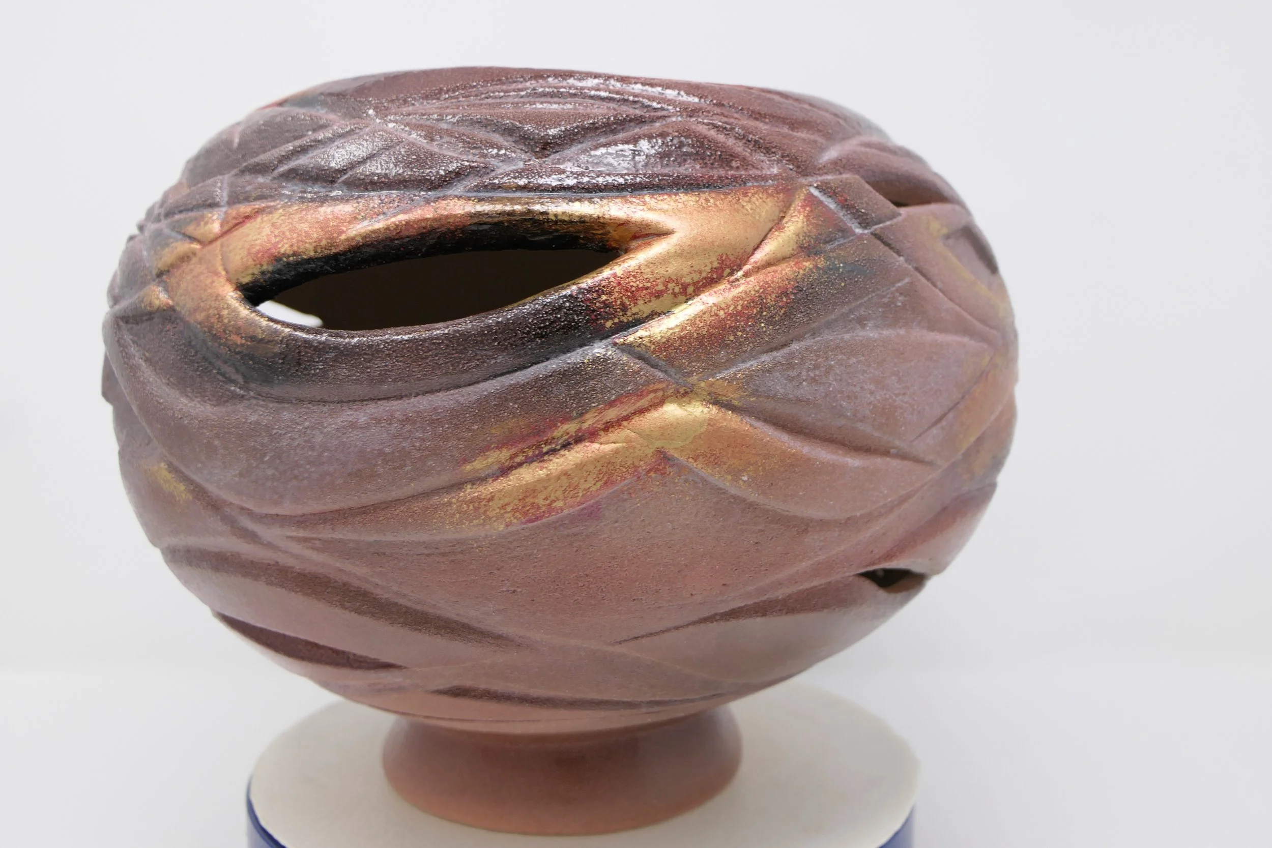 The outer vessel bears the scars. The inner flame continues to glow.