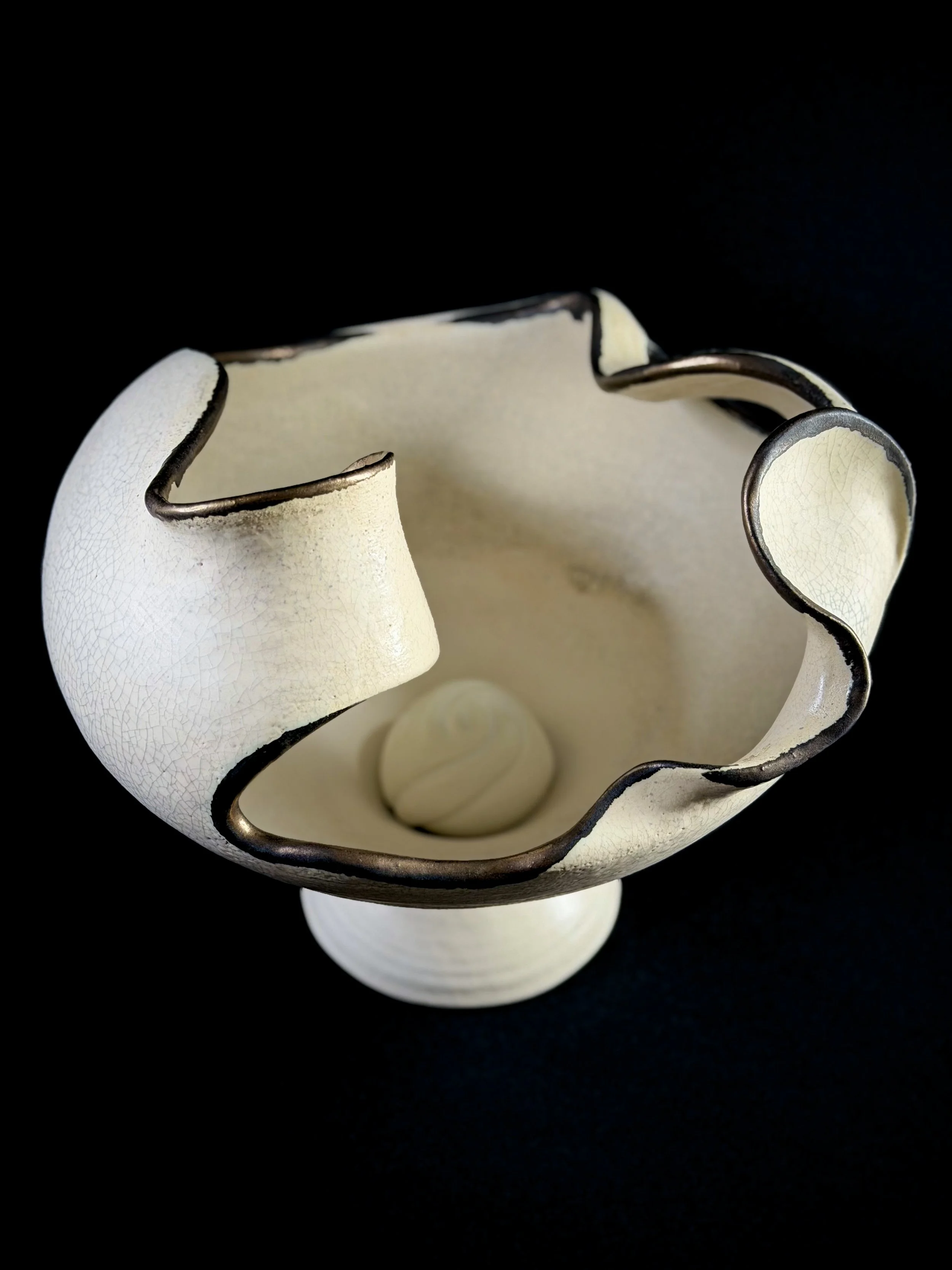 A hidden porcelain form rests within.
Some parts of our story remain protected, even as we grow around them.
