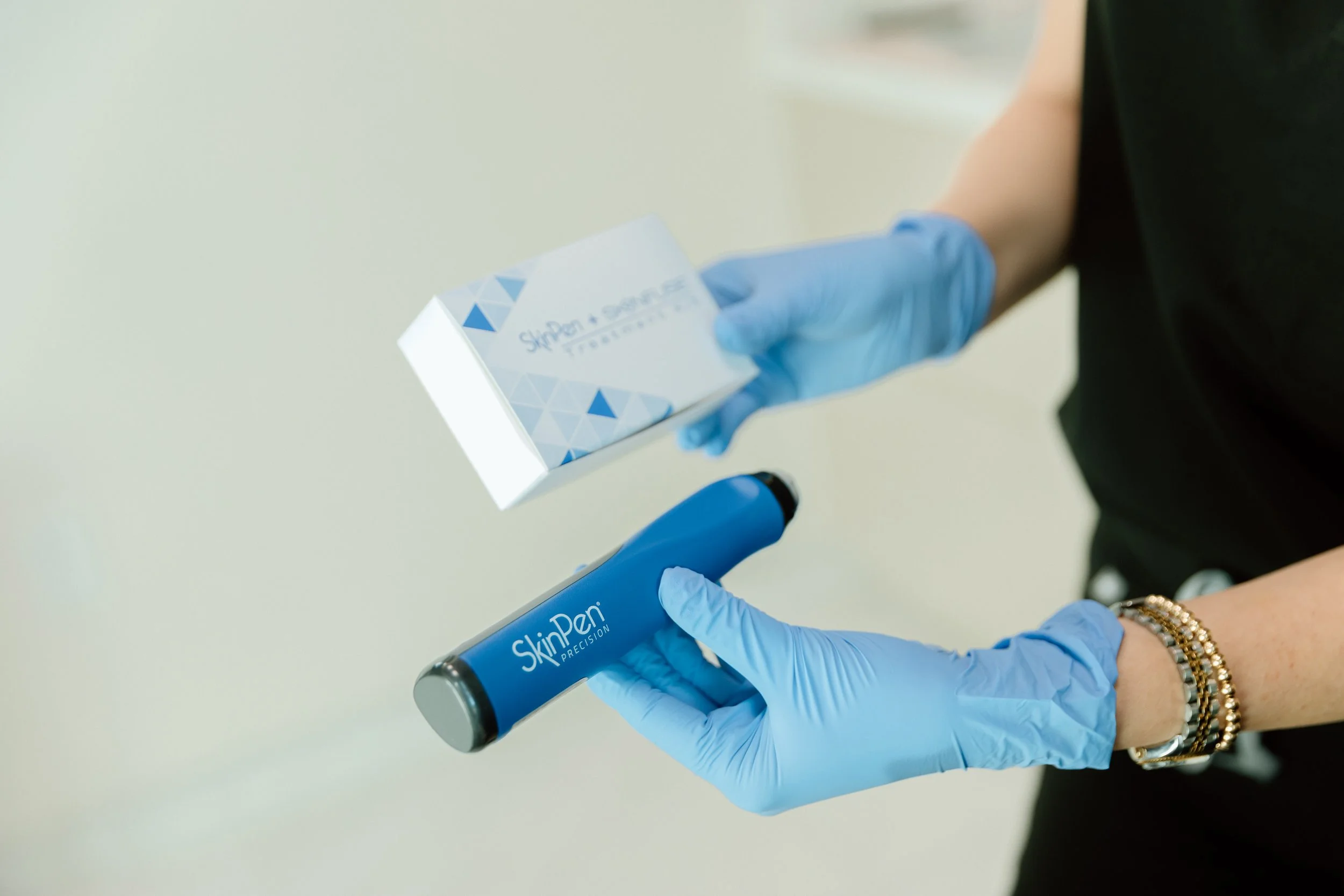 Treatment provider holding a SkinPen Microneedling device in a Scottsdale Med Spa.