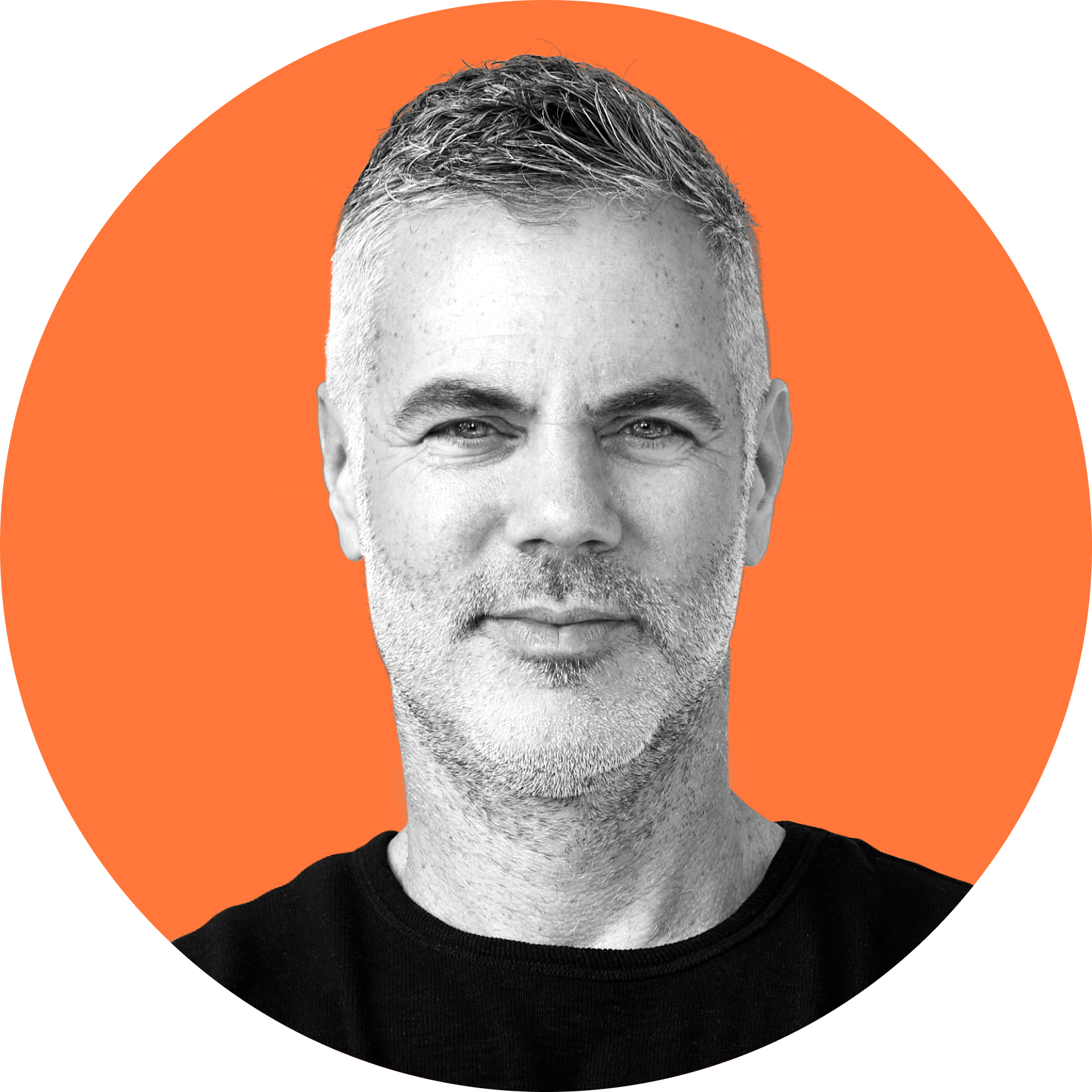 Black and white portrait of Stephen Fogarty with short hair and stubble, wearing a black shirt, against an orange background.