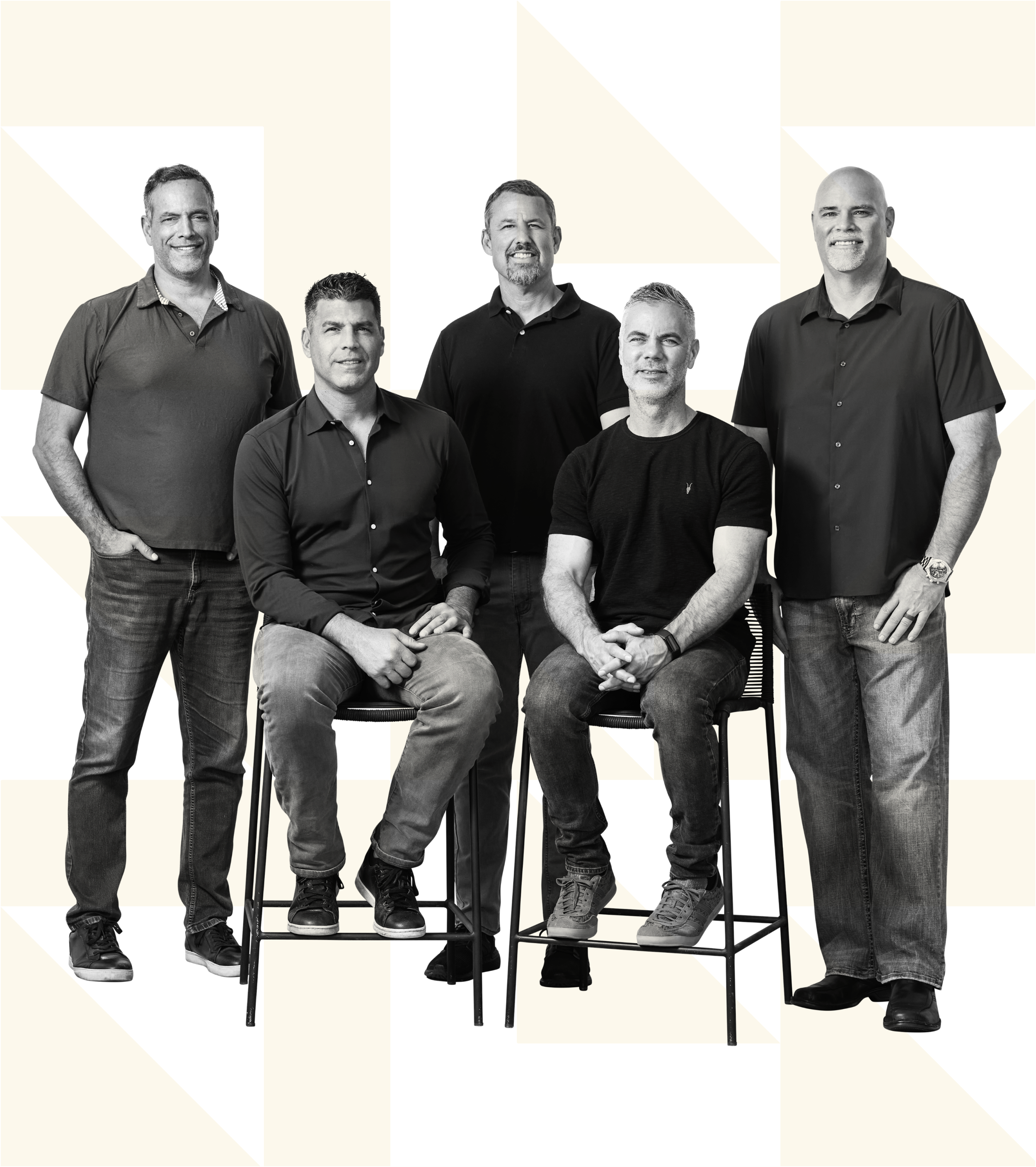 A group of five men who are partners at Scalrr, four standing and one sitting, in casual clothing, smiling or with neutral expressions, posing for a photo in black and white on a geometric background.