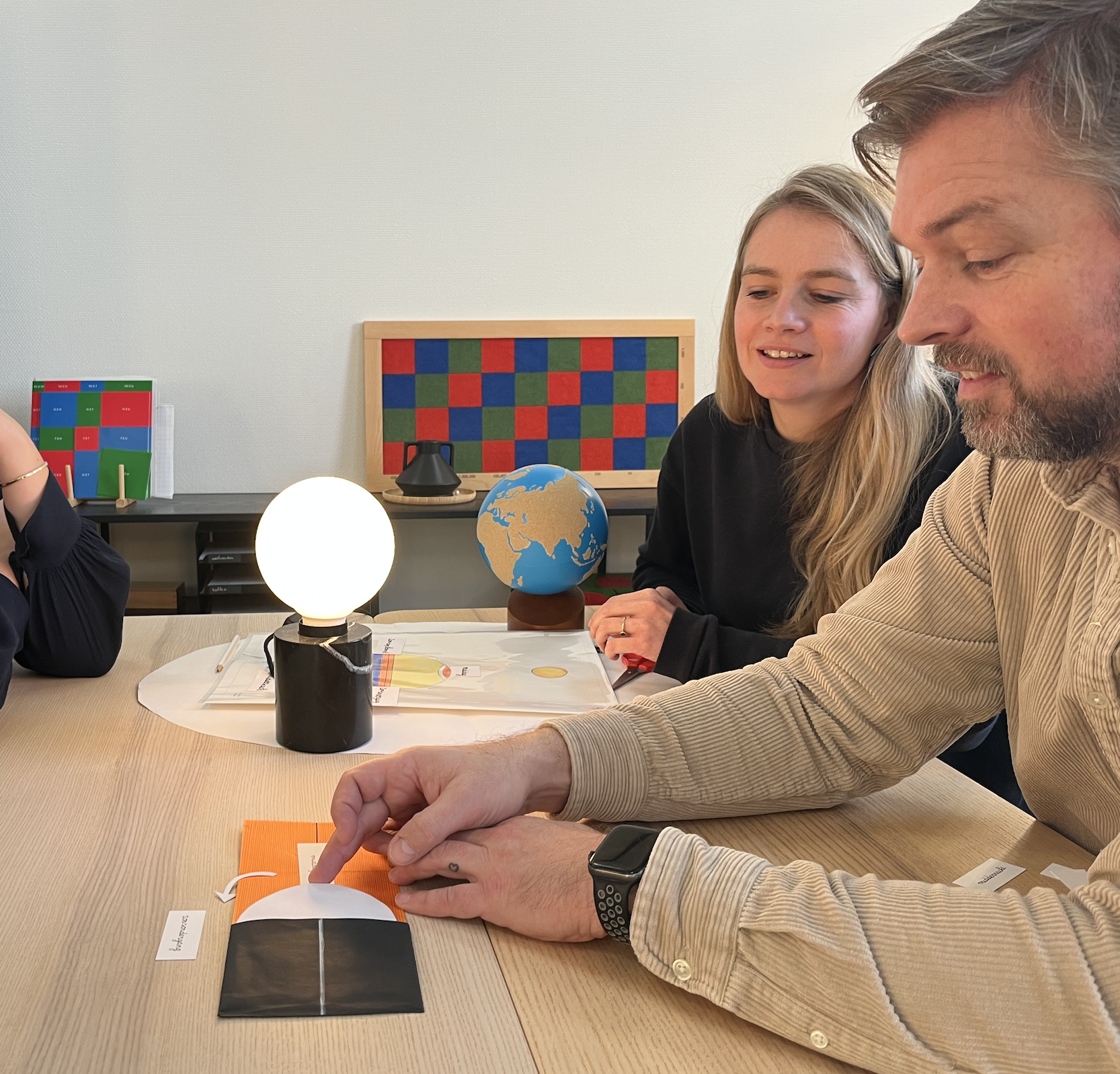 People practicing with Montessori presentations on the Dutch AMI 6-12 Diploma Course.