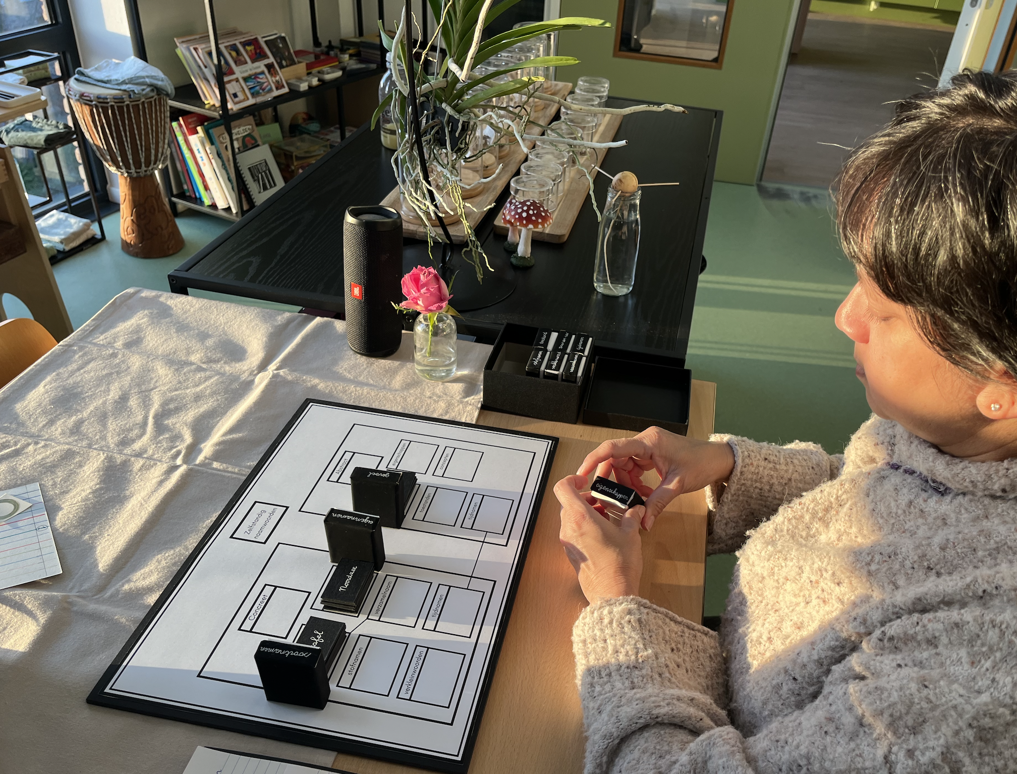 A Woman practicing with Montessori material on the AMI 6-12 Diploma course in Delft at the International Montessori Institute (IMI).