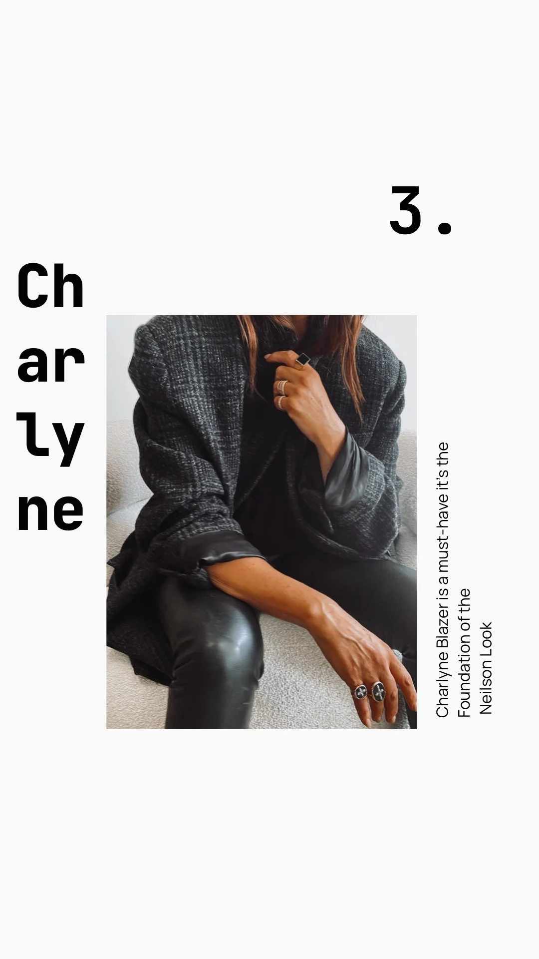 A woman wearing a Charlyne Blazer, black leather pants, and rings, sitting on a light-colored couch with a modern design.