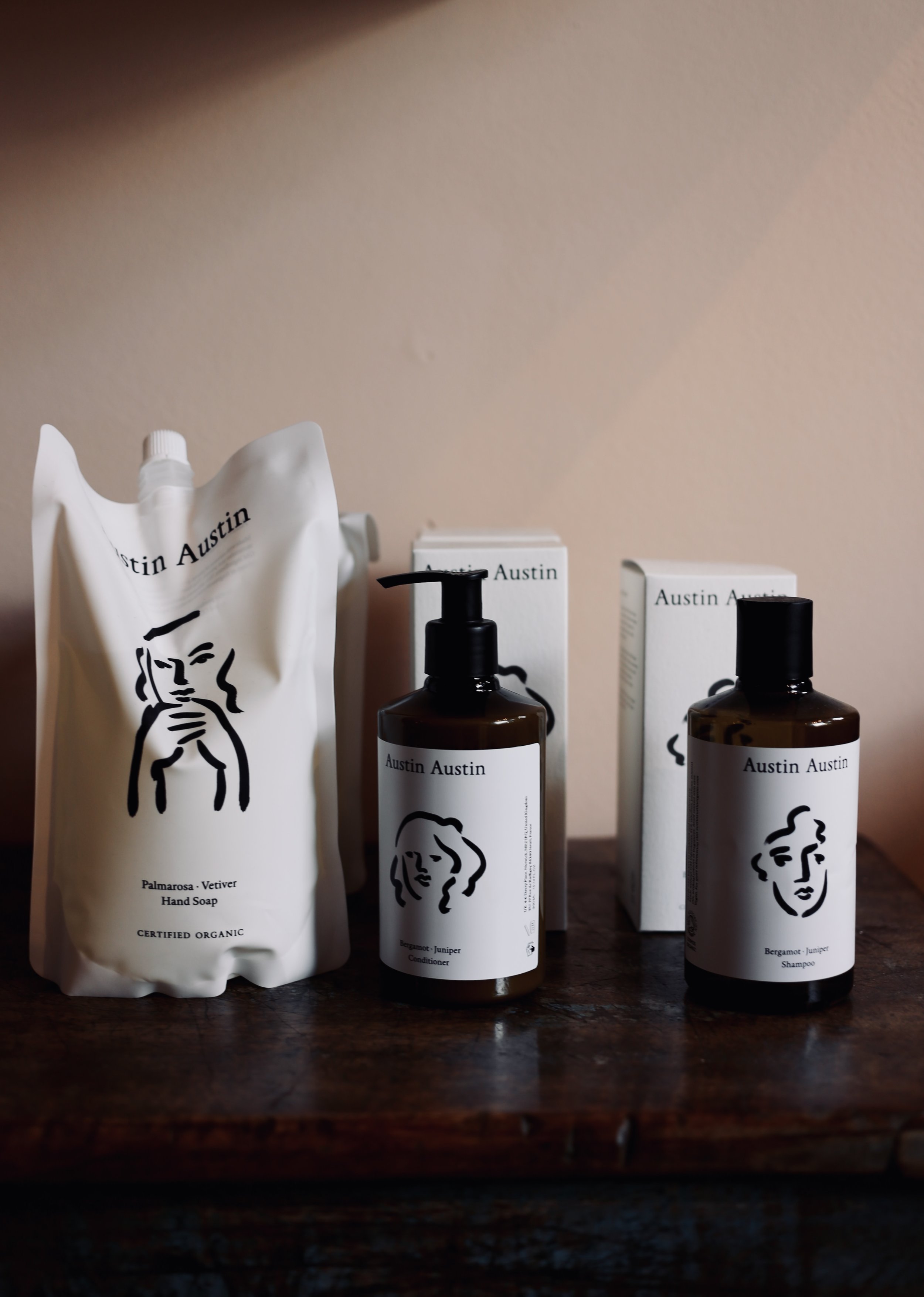 Dallas Austin personal care products on a wooden surface with neutral background.