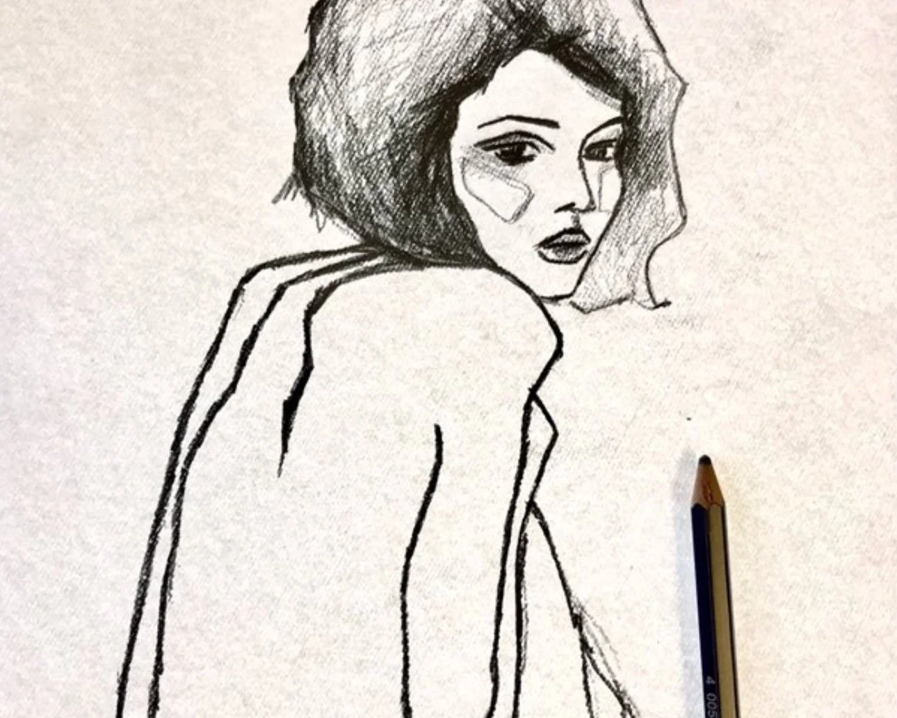 A black and white sketch of a woman with shoulder-length hair, looking over her shoulder with an expressive face. A pen is placed on the paper near her shoulder.