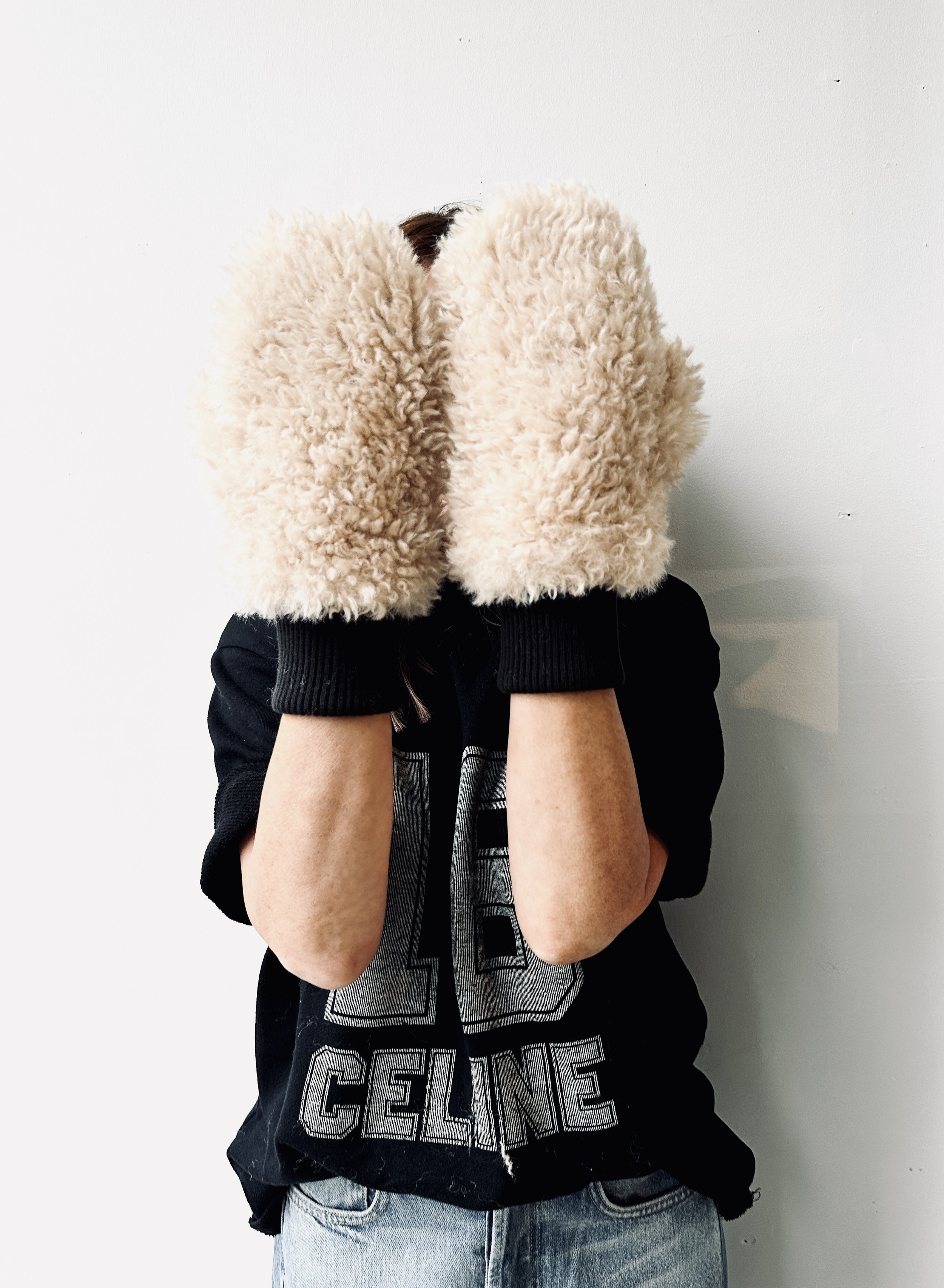 Person wearing a black Celine jacket and cream fluffy slippers, brand lifestyle photography by MUSE Creative Studio Brighton
