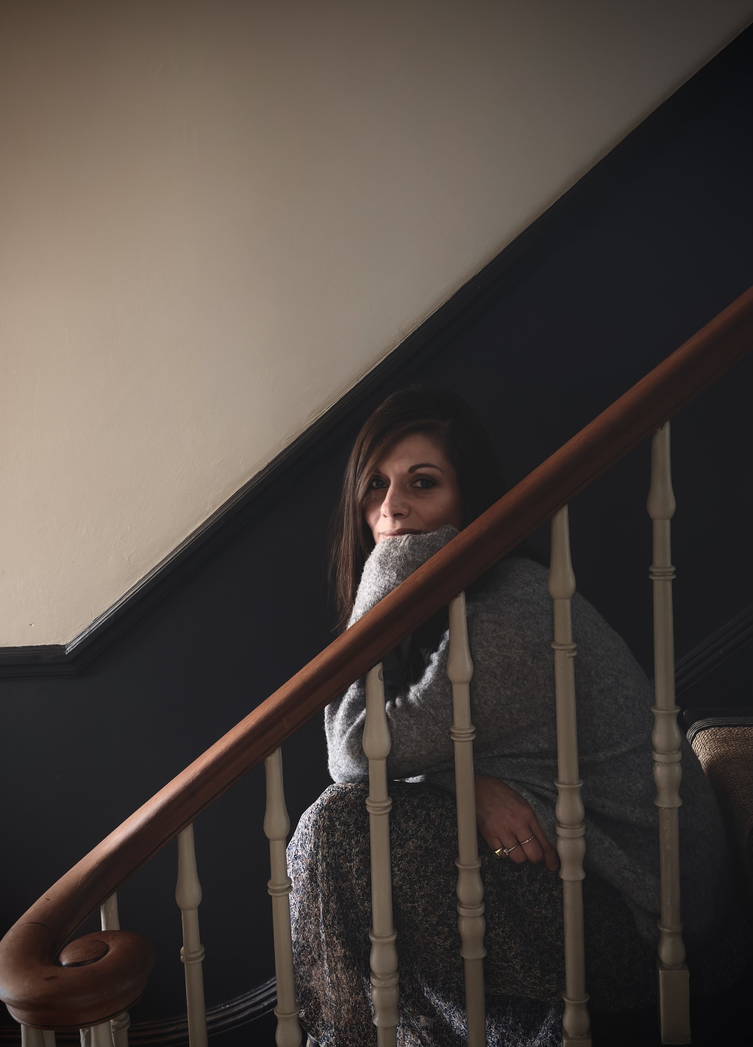 woman sitting in the stairs looking at the camera