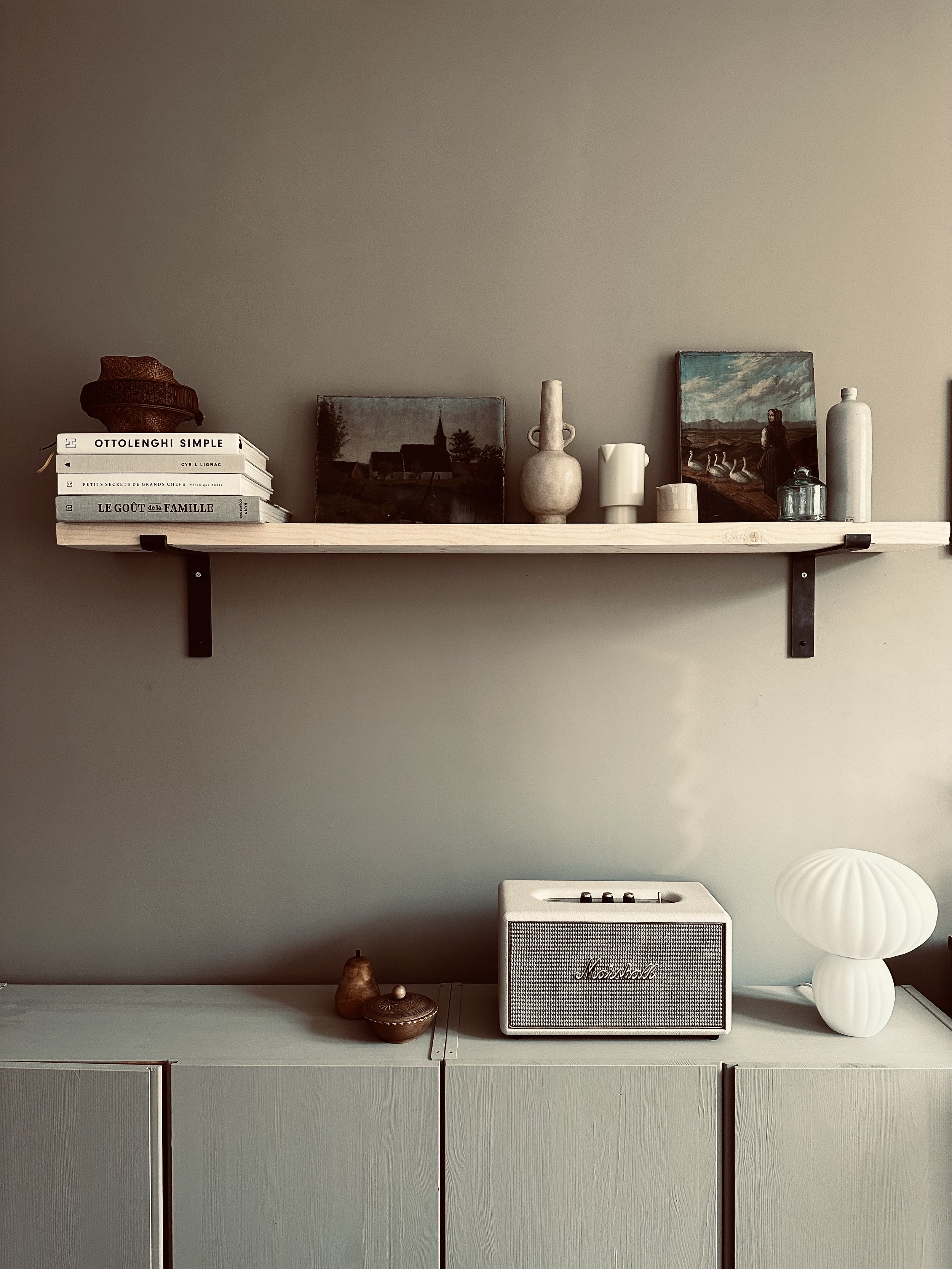 books and vintage objects on a shelve with bracket