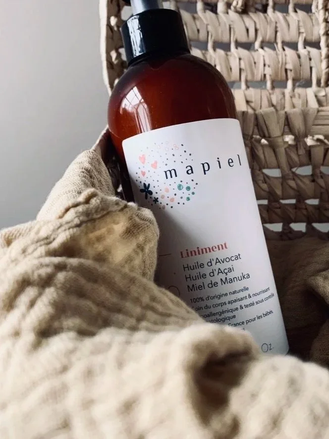 Amber glass bottle of body care on cream knitted fabric