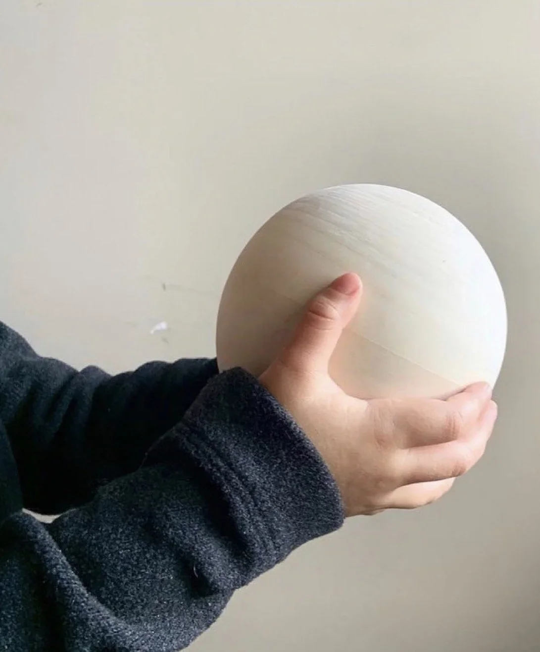 sensory wooden ball in child's hands