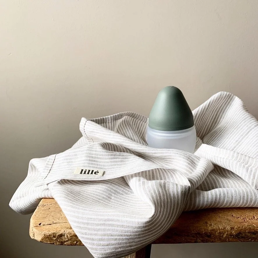 Minimal green ceramic object styled on neutral linen, product photography by MUSE Creative Studio Brighton