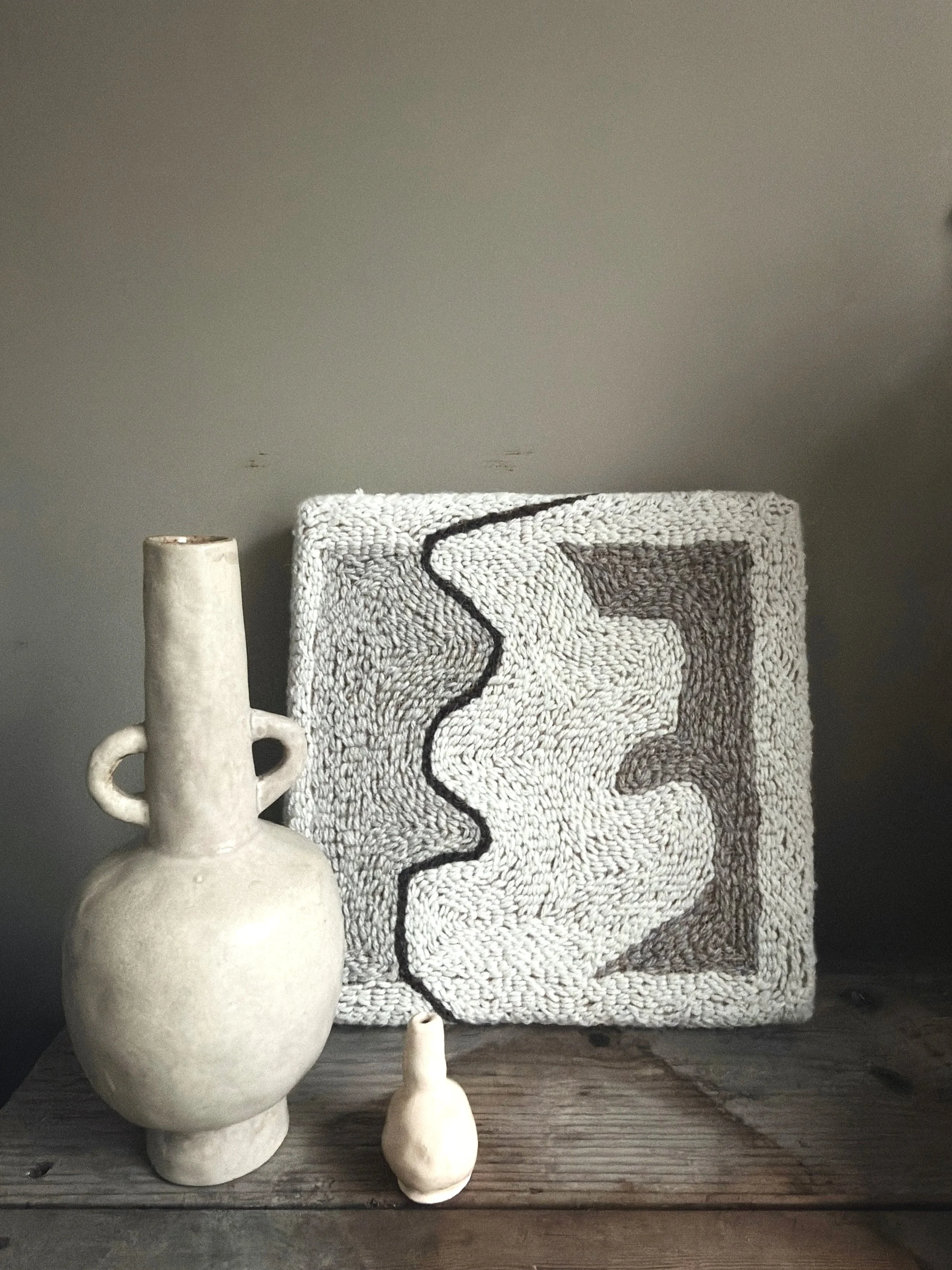 Punch needle textile artwork and ceramic vases styled on wood, art pieces available in The MUSE Shop Brighton