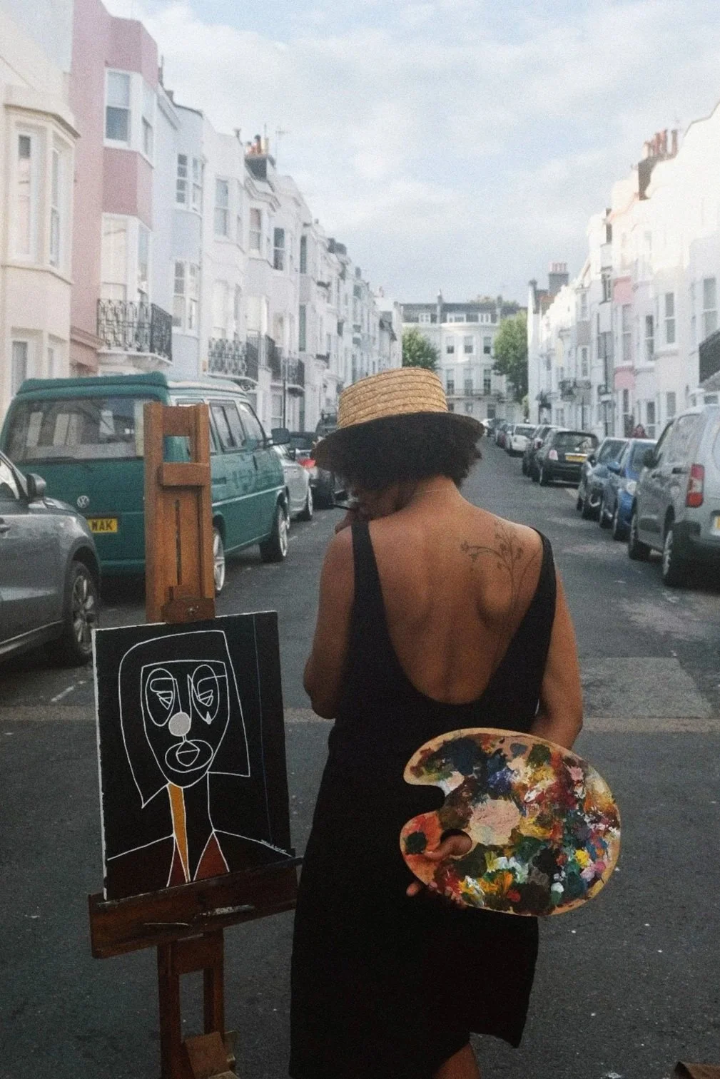 Brighton artist walking with painting on easel and paint palette — artist features by MUSE Creative Studio