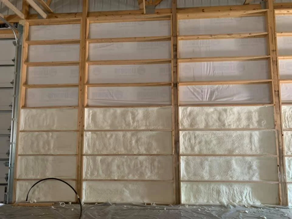 Jobsite_ pole shed by garage overhead door .jpg