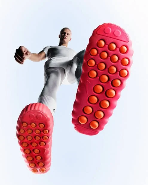 Bottom view of the Nike Mind sensory shoe displaying pink textured foam nodes designed for foot stimulation.