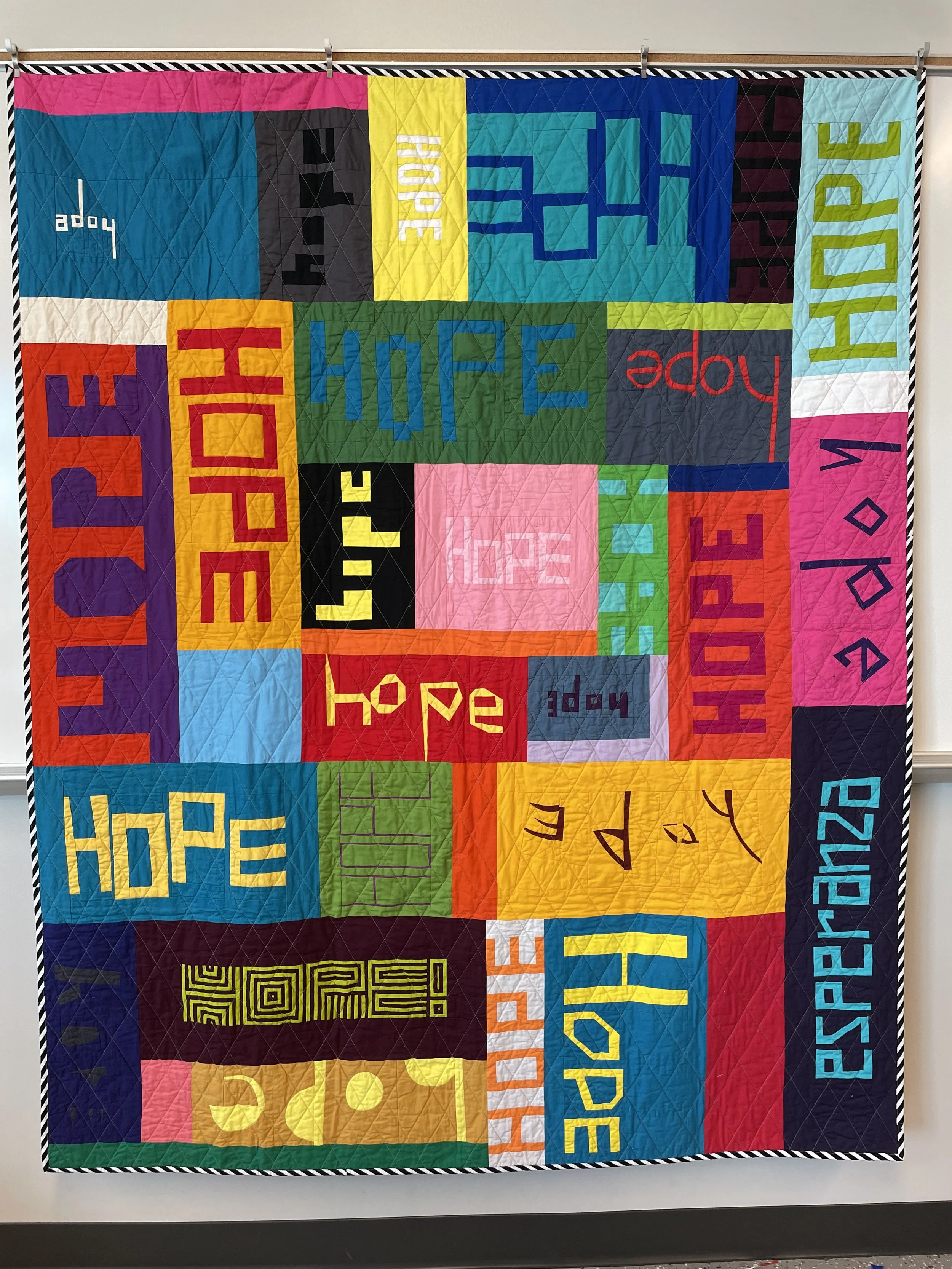 Hope
2022
Cotton fabric and batting, polyester thread
59" x 71.5"

Additional piecers: Charles Cameron, Chris Davies, Sarah Goer, Emily Lang, Allie McCathren, Elizabeth Ray, Sarah Ruiz, Carole Lyles Shaw, Isabelle Selak, Ellyn Zinsmeister.

When choo