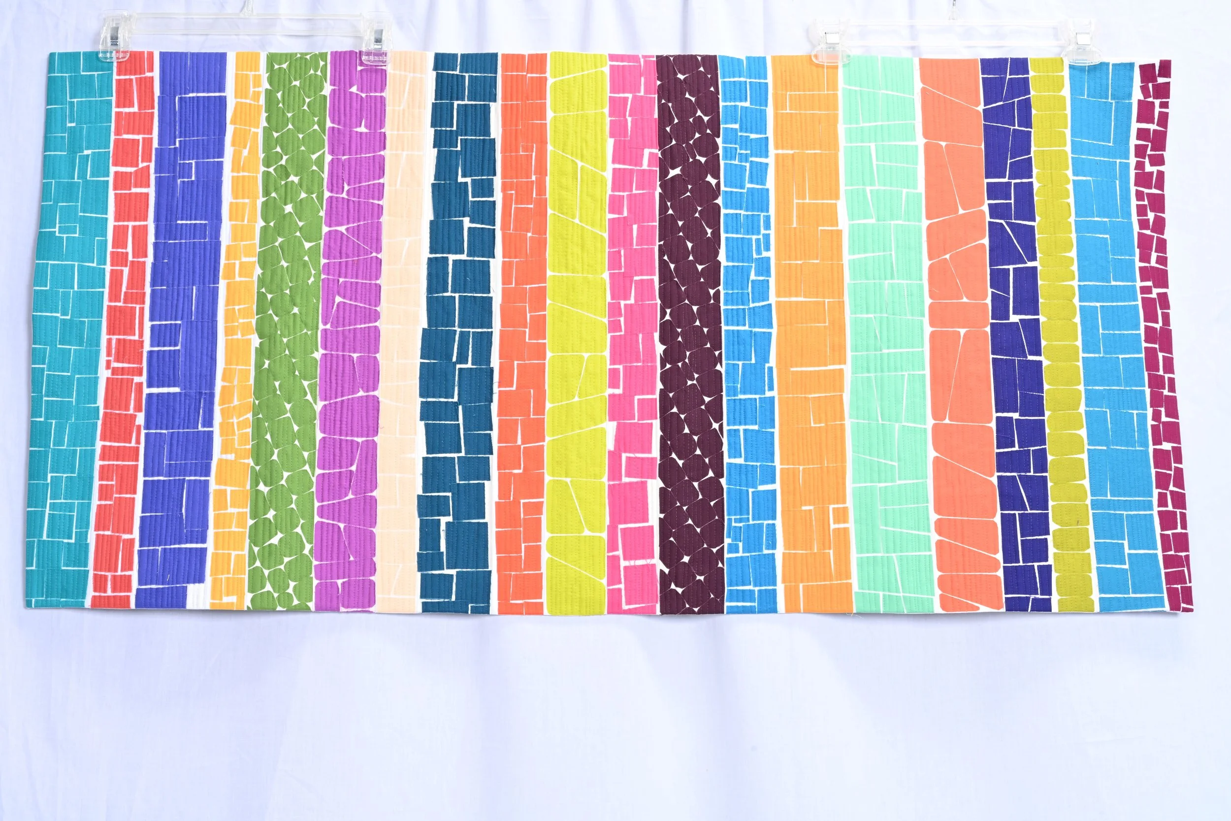 For Alma and Carole
2024
Cotton fabric and batting, plastic thread
45.5 " x 22.5"

Alma Thomas was an African-American artist who is now recognized as a major painter of the 20th century. She is known for her colorful abstract paintings. Members of Q